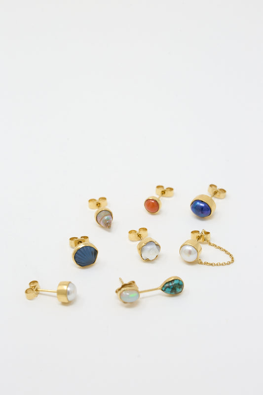 A set of 18K gold-plated silver stud earrings with gemstones and mother of pearl by Grainne Morton.