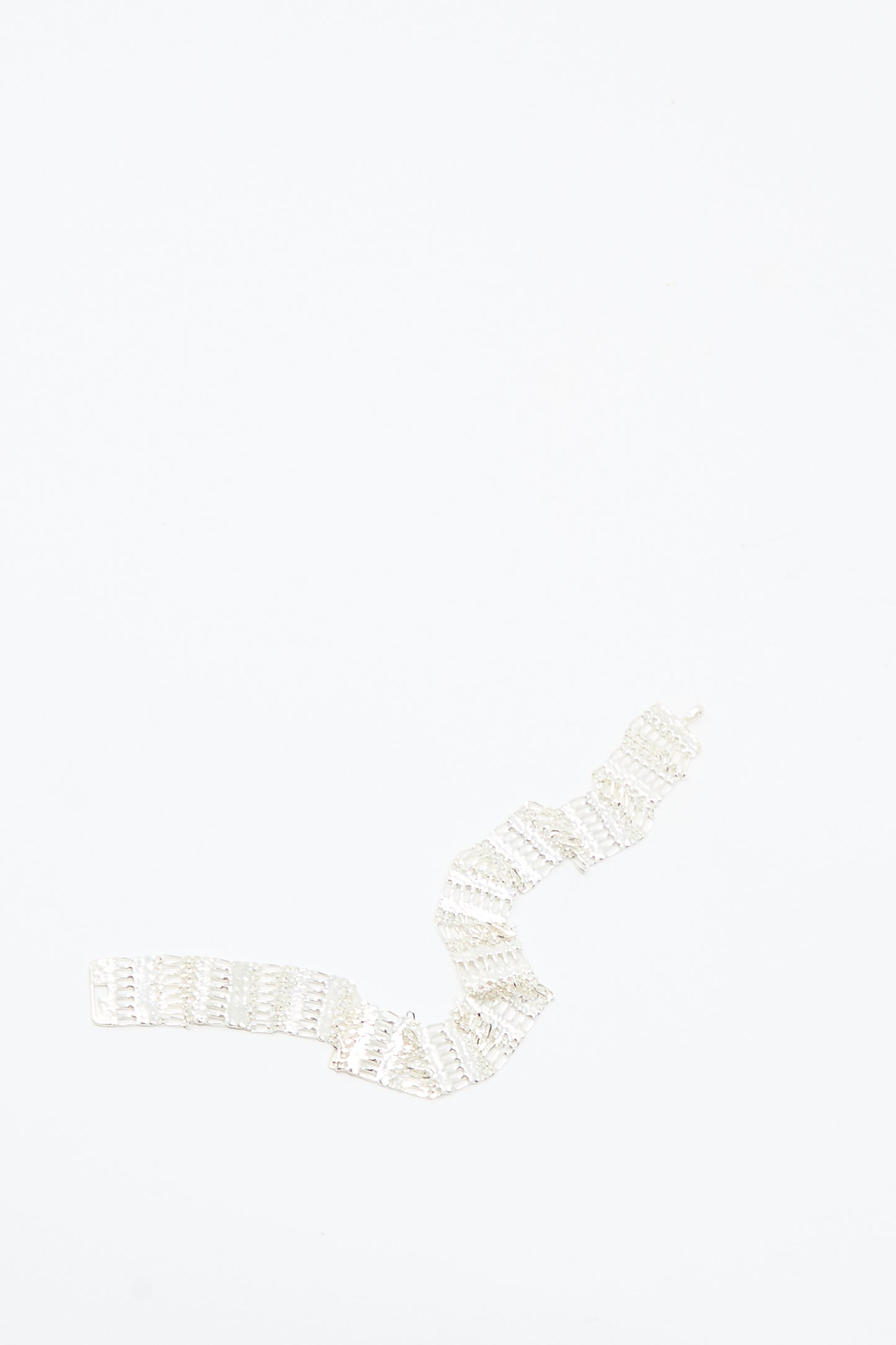 The Friendship Bracelet in Silver by Hannah Keefe, a handmade sterling silver piece with a zigzag design, rests on a plain white background.