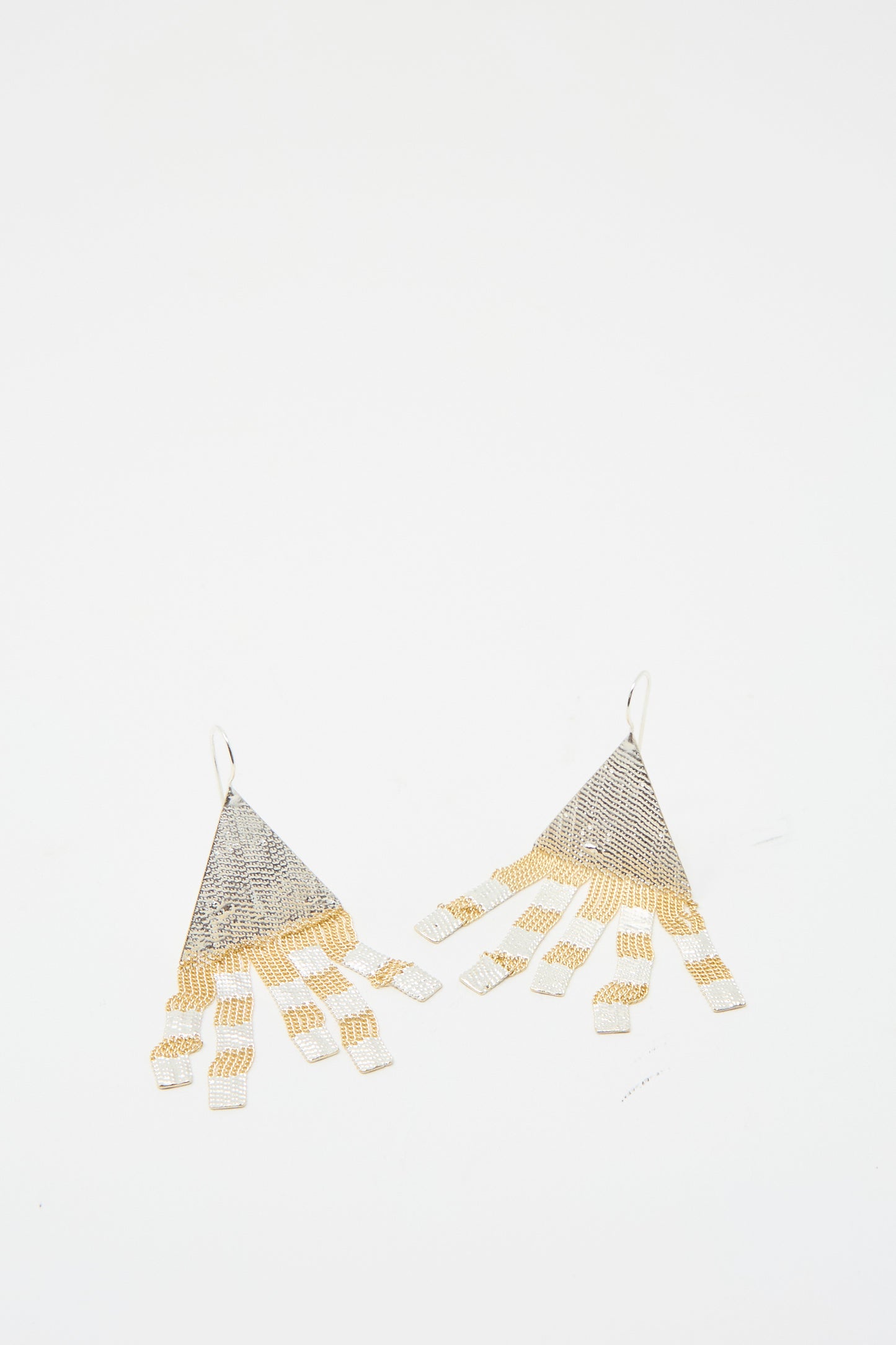 Scotch Earrings by Hannah Keefe, featuring a triangular mesh design with gold and silver fringes, set against a white background.