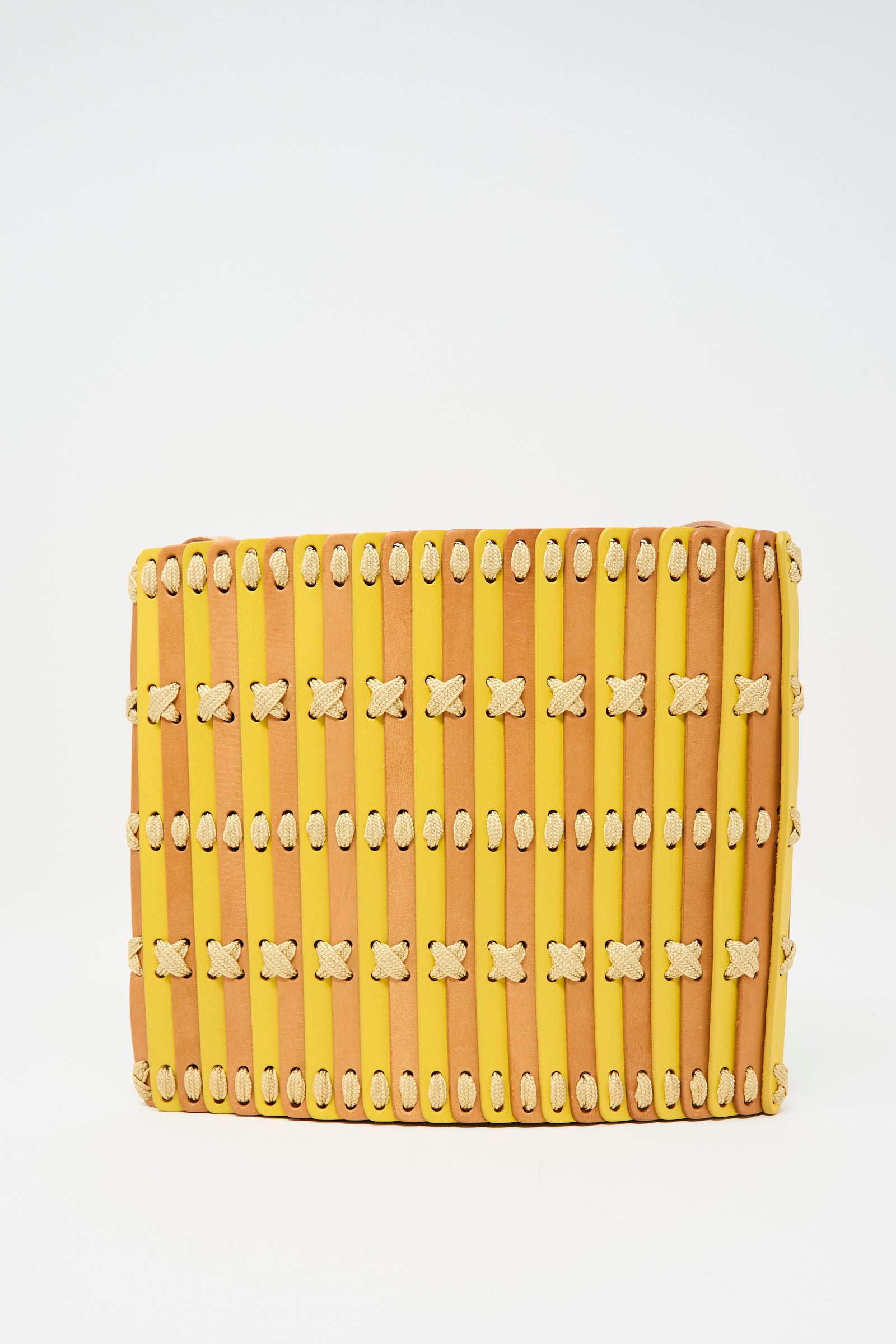The Hatori Leather Crossbody 48 in natural and yellow with ecru lace features vertical slats, cream-colored threaded details, an adjustable strap, and handcrafted leather—displayed against a plain white background.