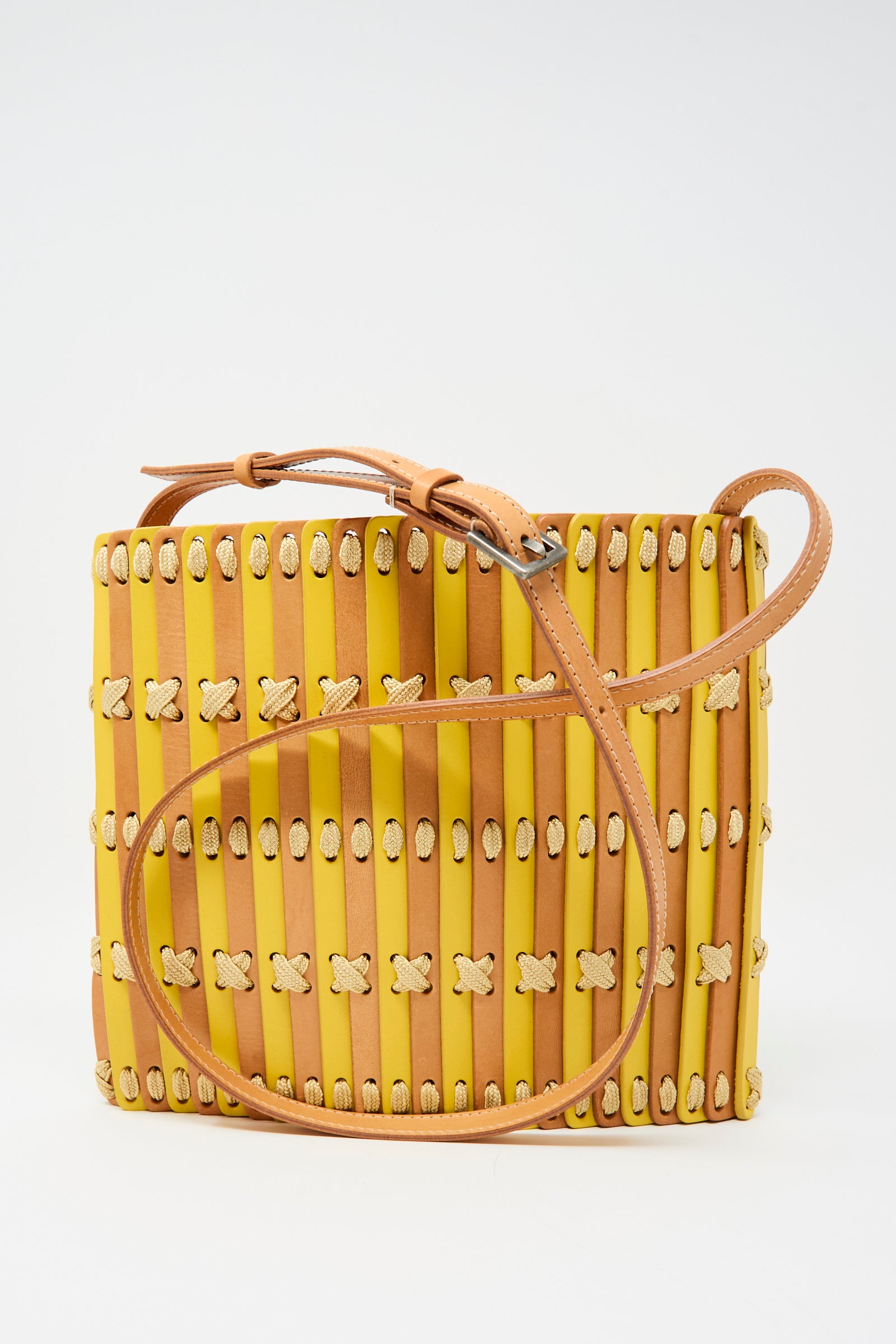 The Hatori Leather Crossbody 48 in Natural and Yellow with Ecru Lace features a square shape, vertical strips, cream woven details, and a tan adjustable strap, all expertly handcrafted and displayed on a plain white background.