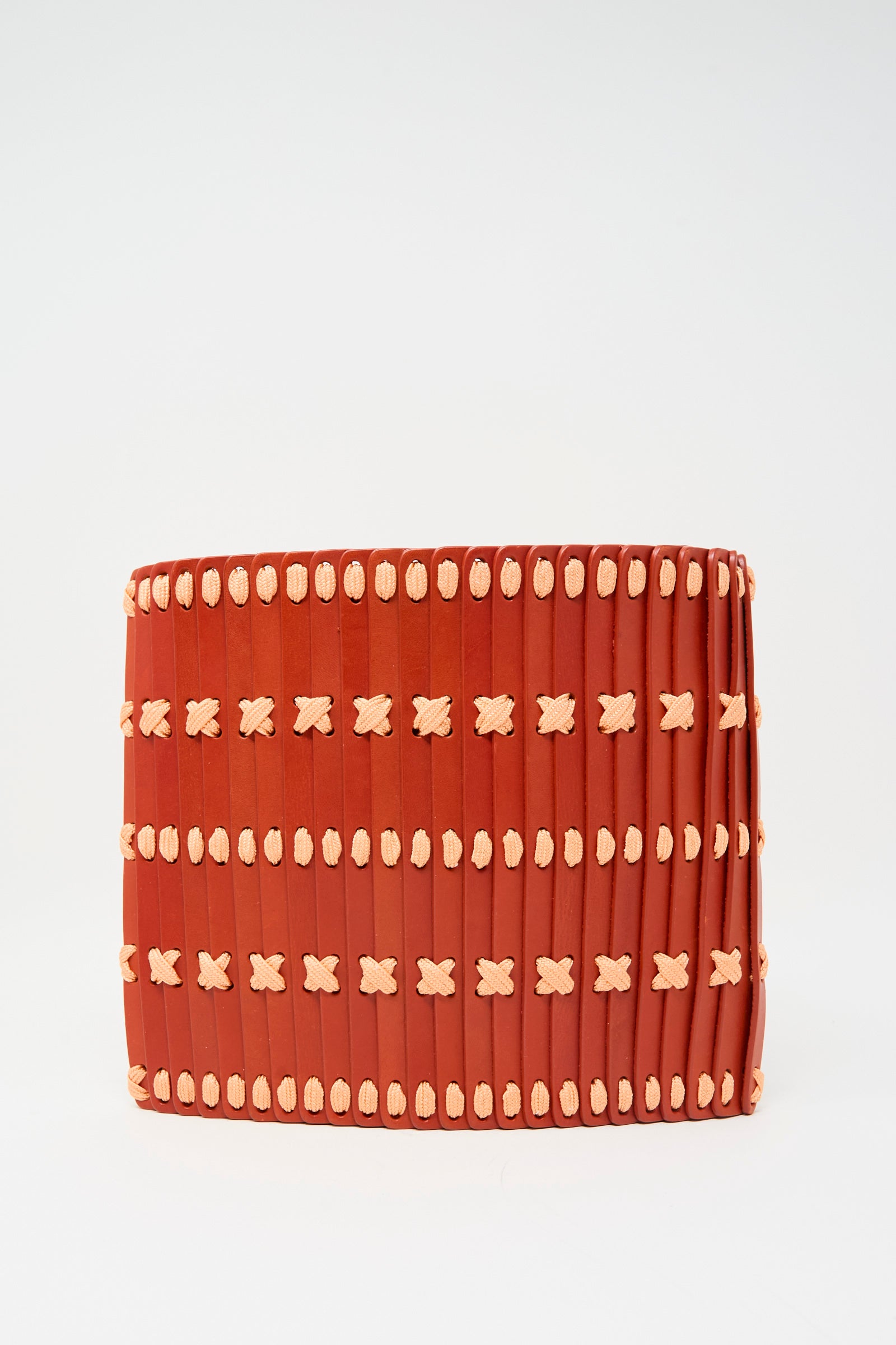 The Hatori Leather Crossbody 48 Bag in Tomato with Pink Lace features vertical red panels and horizontal beige stitches on leather, presented against a plain white background.