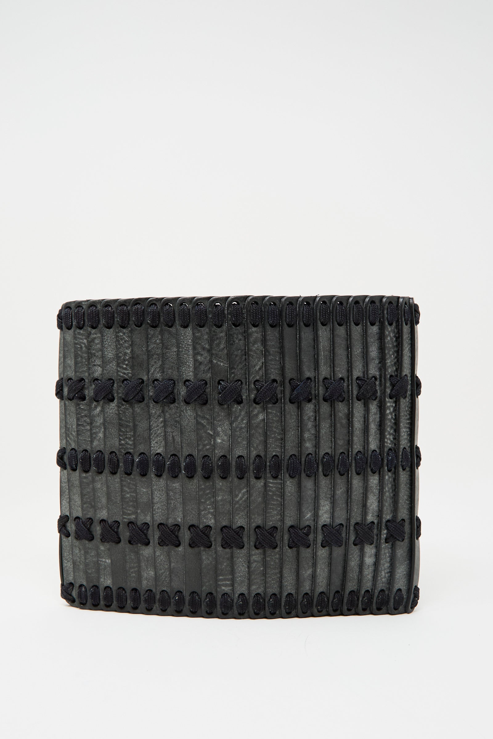The Hatori Leather Crossbody 48 Bag in Waxed Coated Black with Indigo Lace features a textured, ribbed surface and black crisscross stitching, shown against a plain white background.
