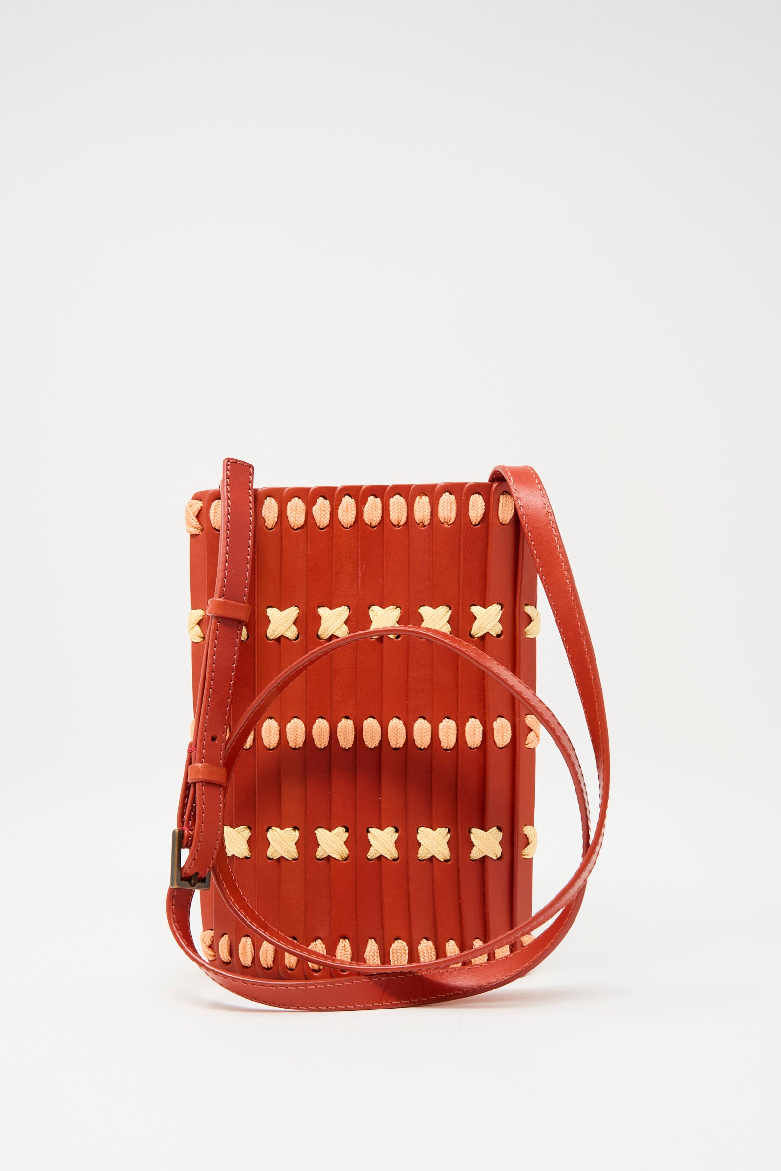 The Hatori Leather Phone 26 Bag in Tomato features lemon and pink lace details and an adjustable strap—against a white backdrop.