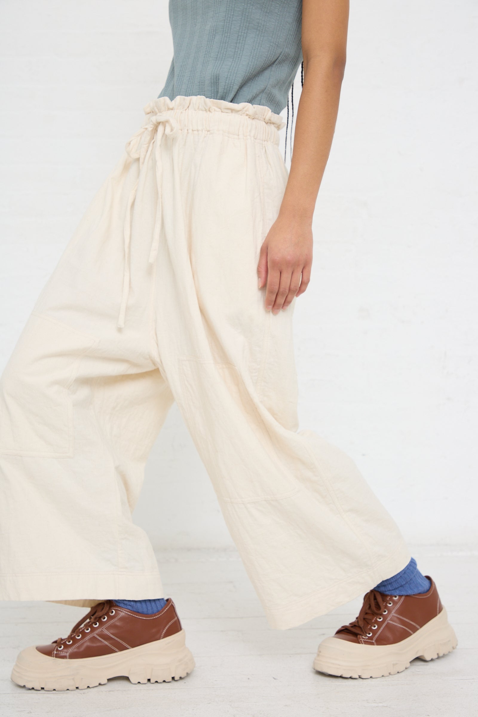 Person wearing Azumadaki Cotton Quilt Pant in Ivory oversized wide-leg pants by Ichi Antiquités and brown platform shoes.