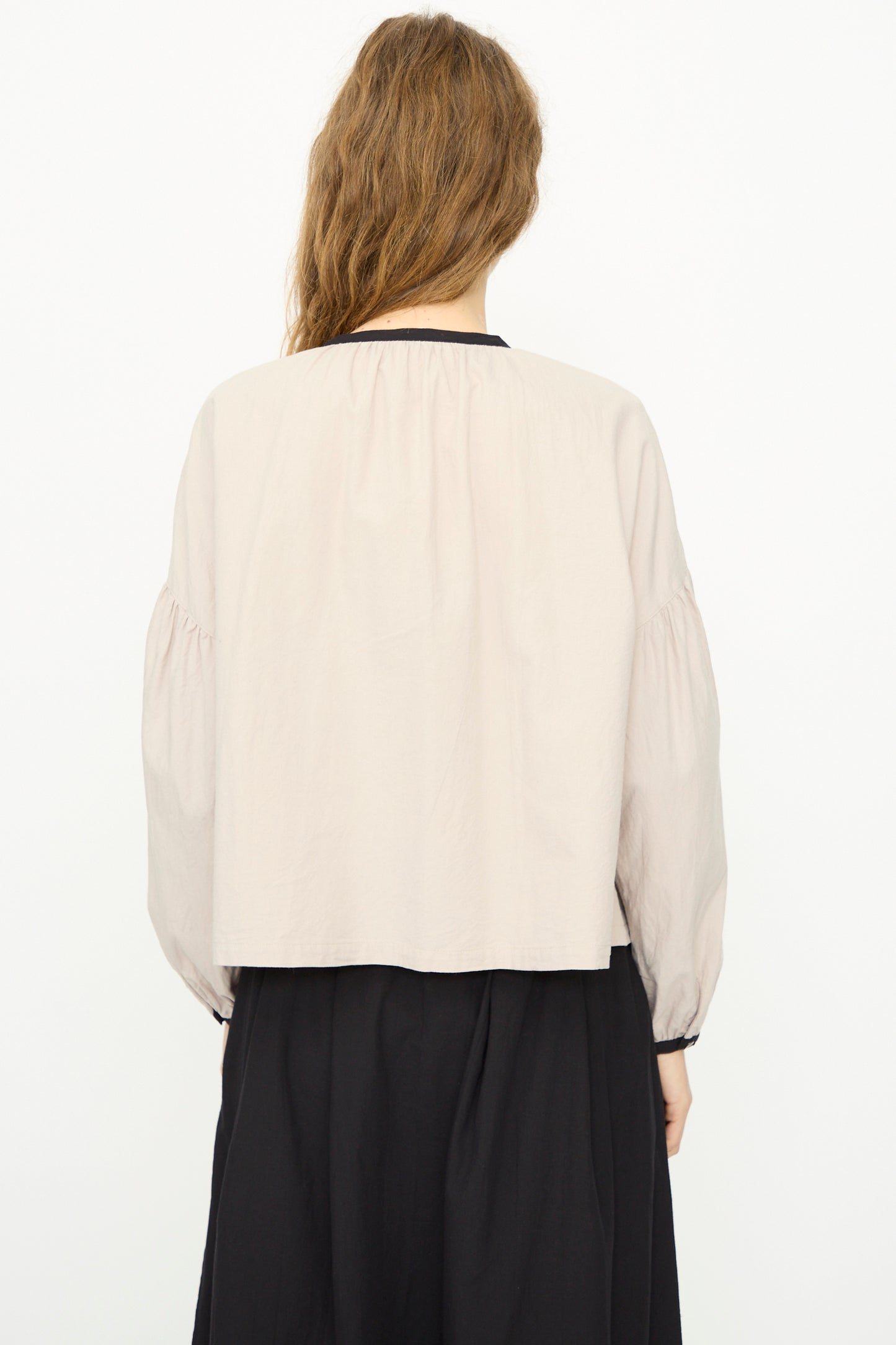 A person with long brown hair wears the Ichi Antiquités Cotton Cashmere Viyella Shirt in Natural and a dark skirt, facing away from the camera against a plain white background. Made in Japan.