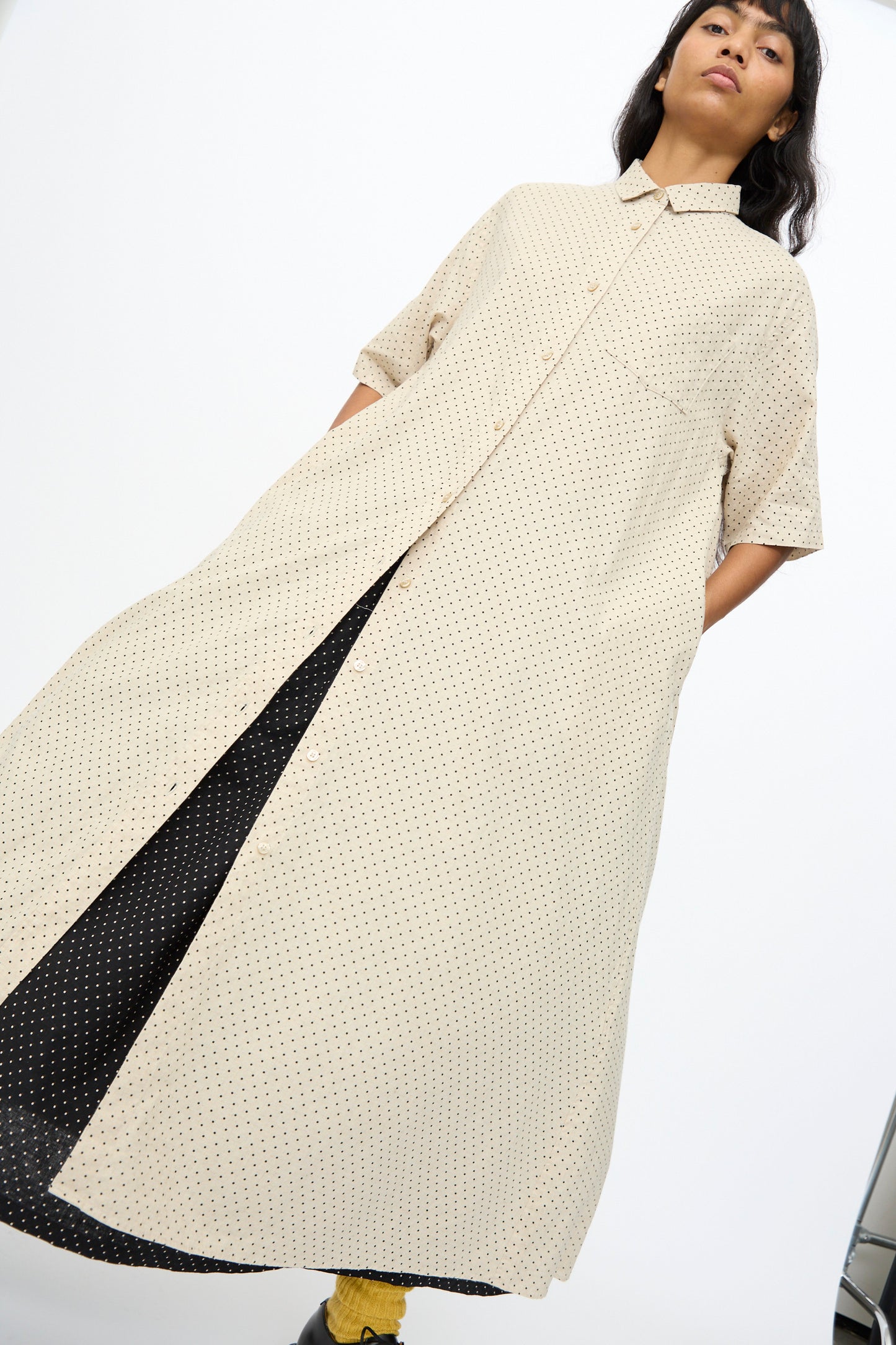 A person models the Ichi Antiquités Cotton Linen Dot Dress in Natural—an ankle-length, short-sleeve, light beige polka dot piece—against a plain white background.