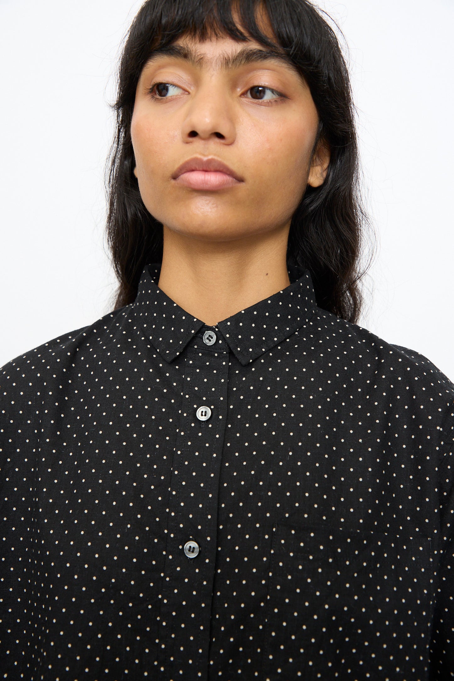 A person with long dark hair wears the Ichi Antiquités Cotton Linen Dot Shirt in Black, looking slightly to the side against a plain background.