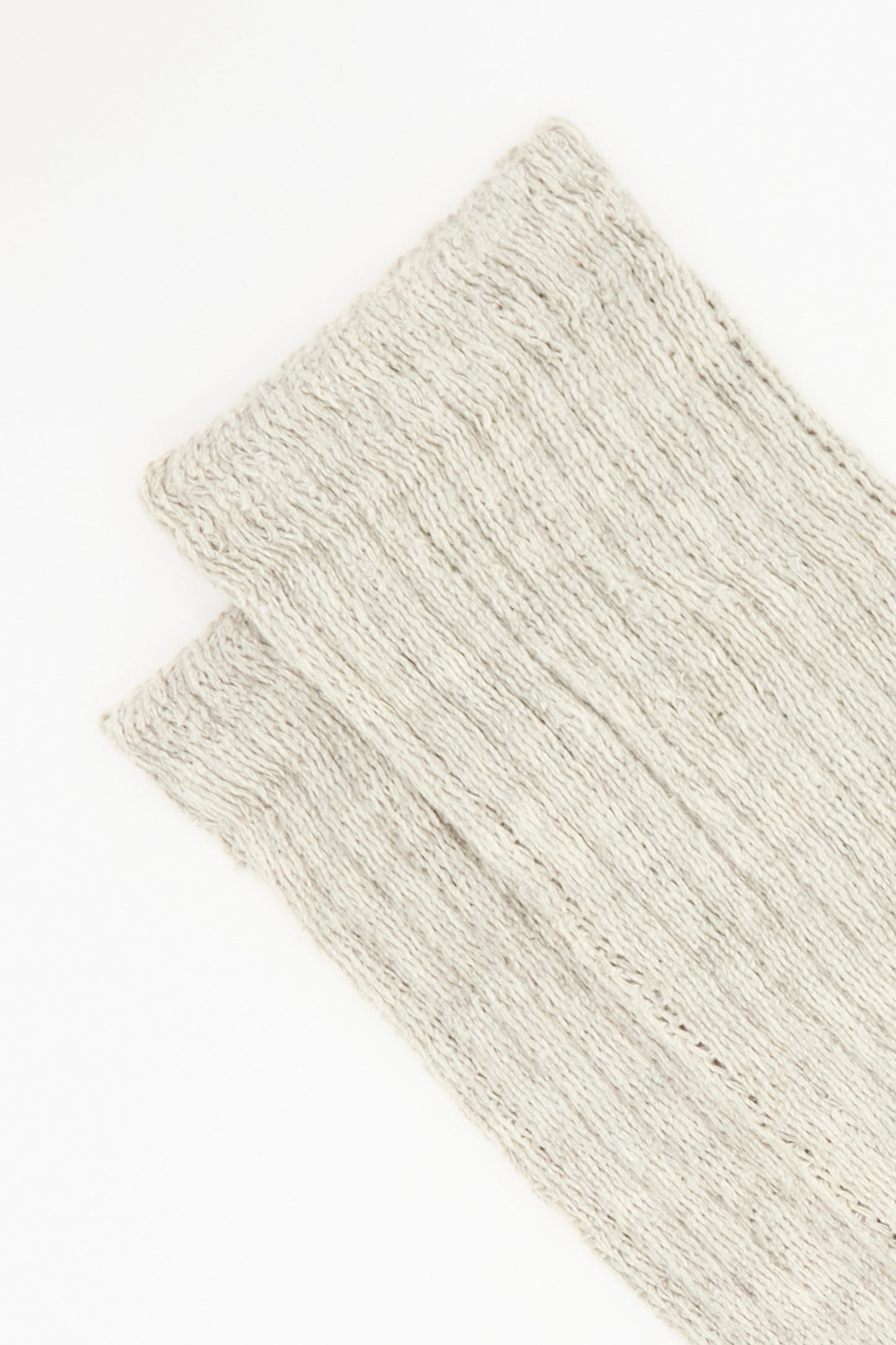 A close-up of two folded Ichi Antiquités Cotton Rib Socks in grey, made in Japan, displayed on a white background.