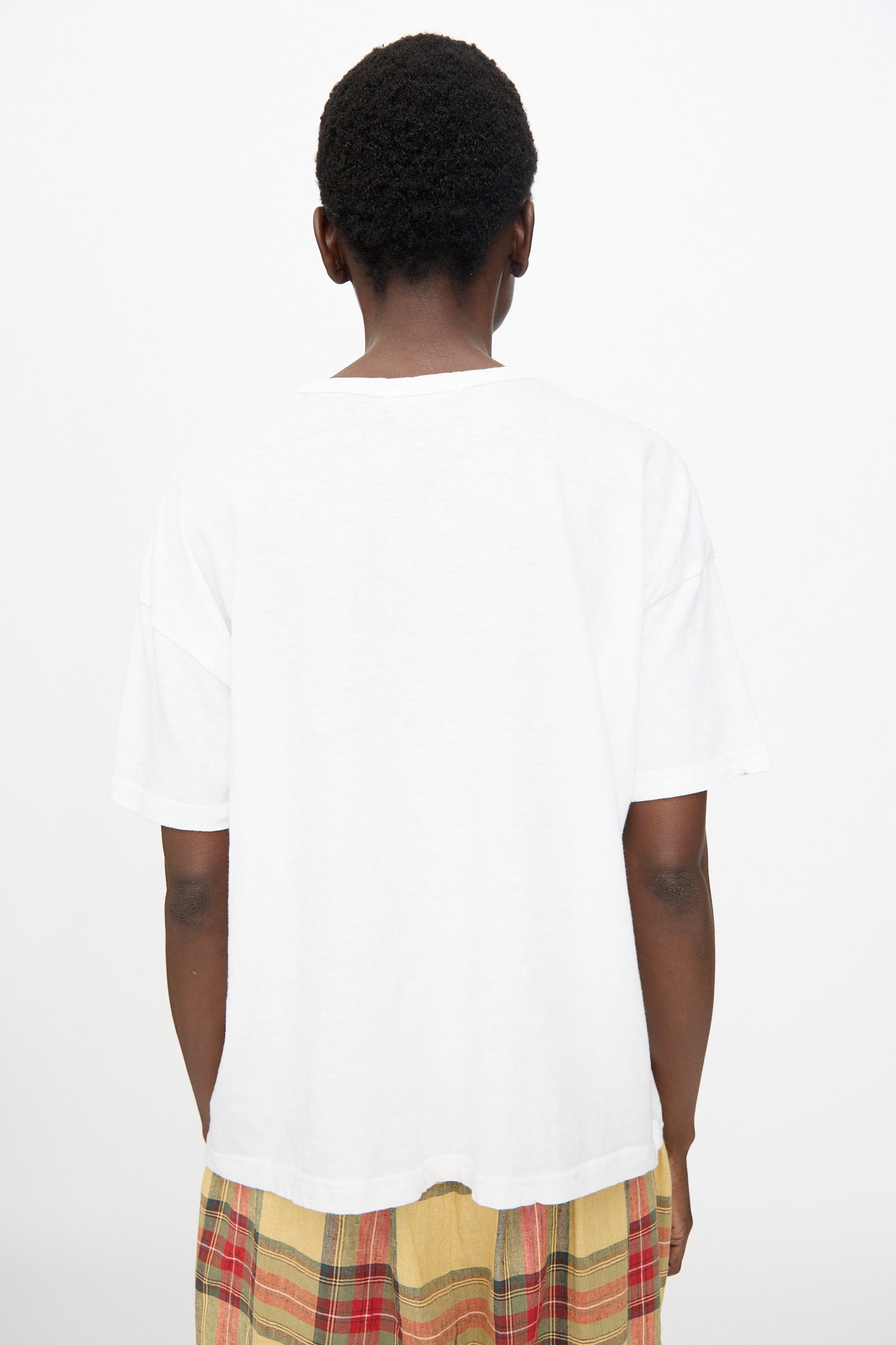 A person stands with their back to the camera, wearing the Ichi Antiquités Cotton T-Shirt in White, styled for an oversized fit and photographed against a plain white background.