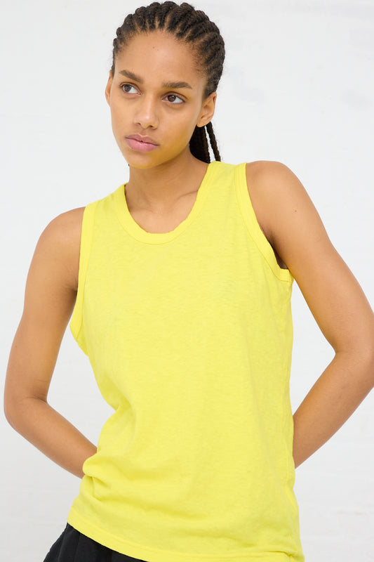 Woman in a Cotton Tank in Lemon by Ichi Antiquités with a pensive look.