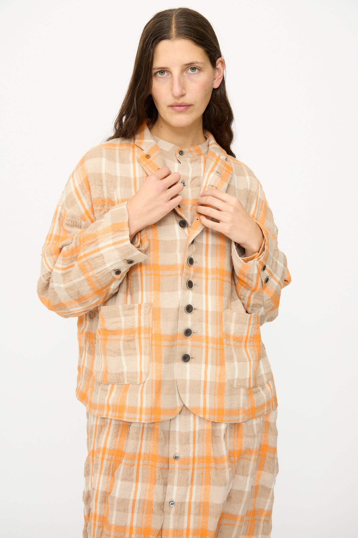 A person with long brown hair wears the Ichi Antiquités Cotton Wool Tartan Check Jacket in Orange, standing against a plain white background.