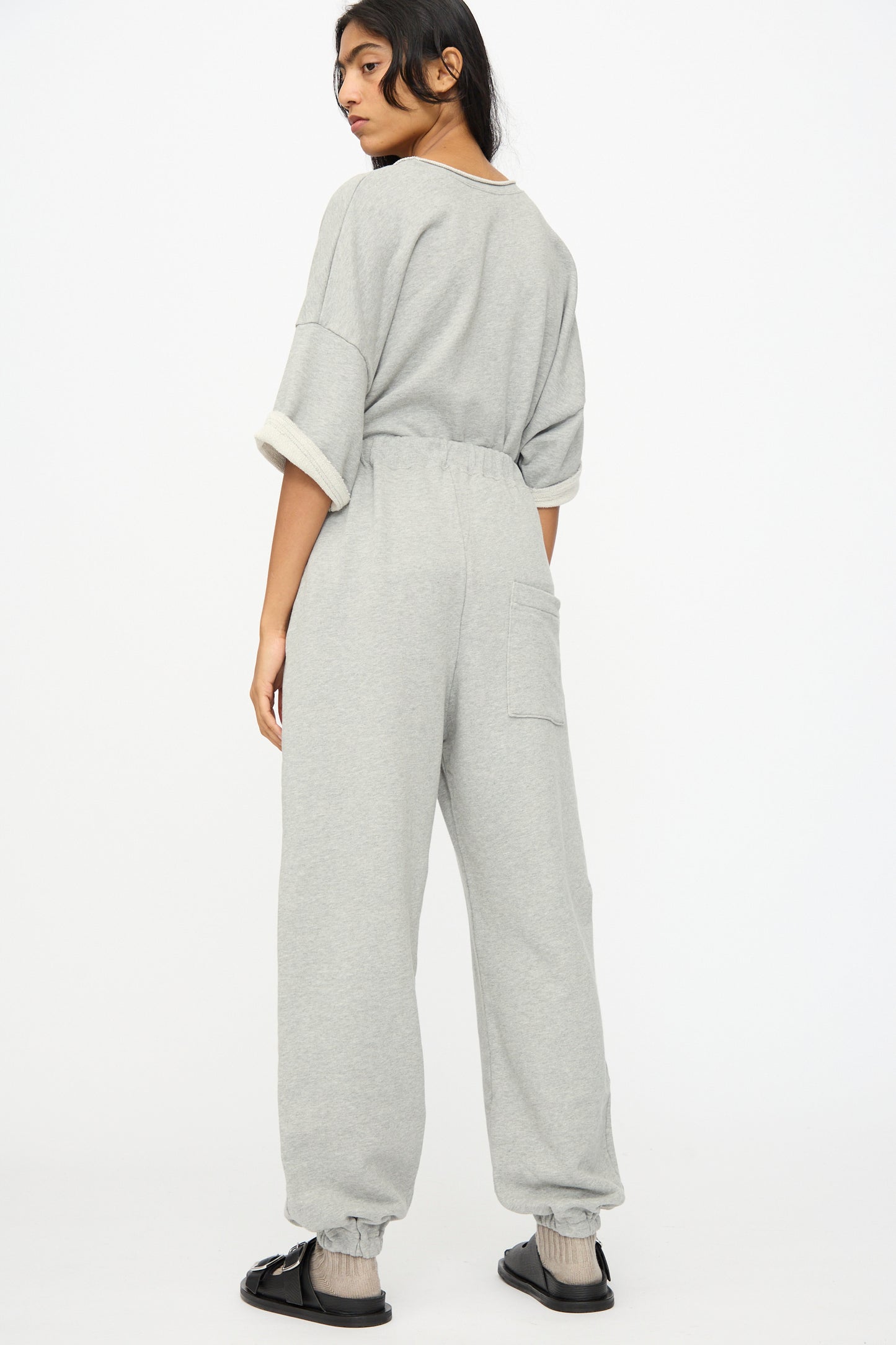 Model wears Ichi Antiquités French Terry Pants in Gray with black sandals, standing with their back to the camera against a plain white background.
