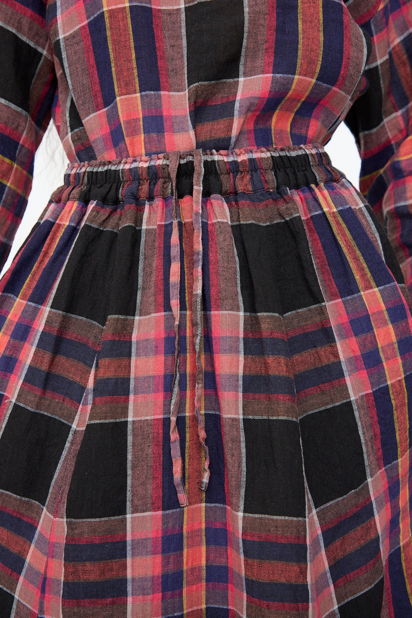 Close-up of the Linen Check Skirt in Black by Ichi Antiquités, featuring plaid red, black, and blue stripes, an A-line silhouette, cinched elastic waistband with fabric drawstring, crafted from a soft linen-cotton blend.