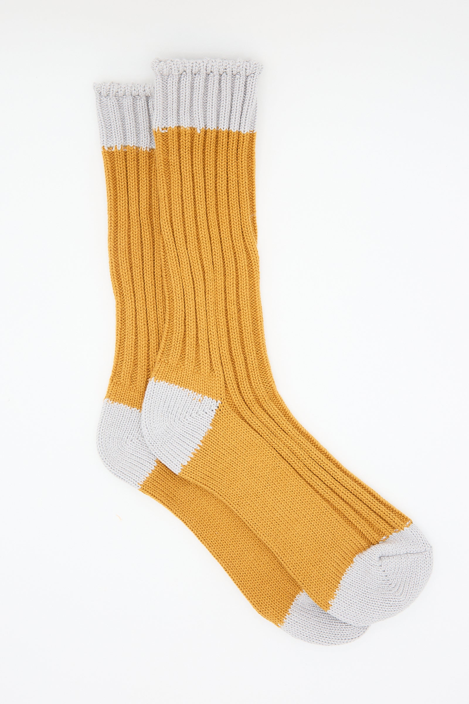 A pair of Ichi Antiquités Organic Cotton Rib Socks in Mustard, isolated on a white background.