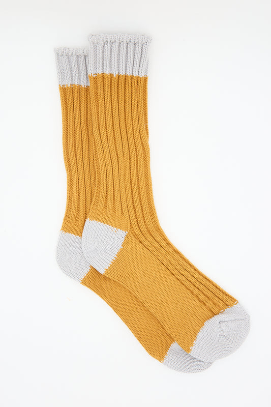 A pair of Ichi Antiquités Organic Cotton Rib Socks in Mustard, isolated on a white background.