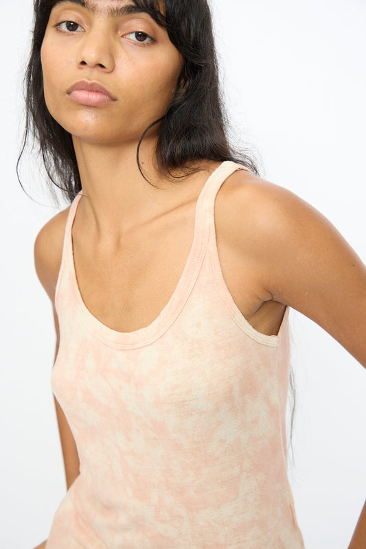 A woman with long dark hair wears the Ichi Antiquités Silk Jersey Tie Dye Tank in Light Pink Mahogany, standing against a plain white background.