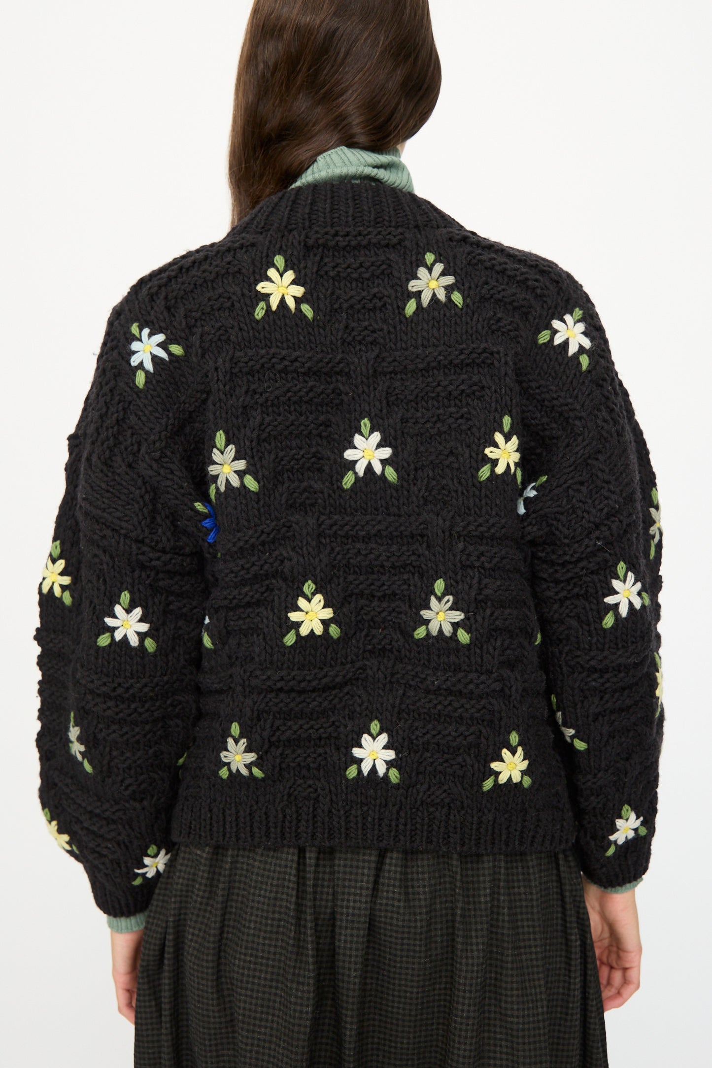 A person with long brown hair is shown from the back wearing the Ichi Antiquités Wool Hand-knit Pullover with Flowers in Black.