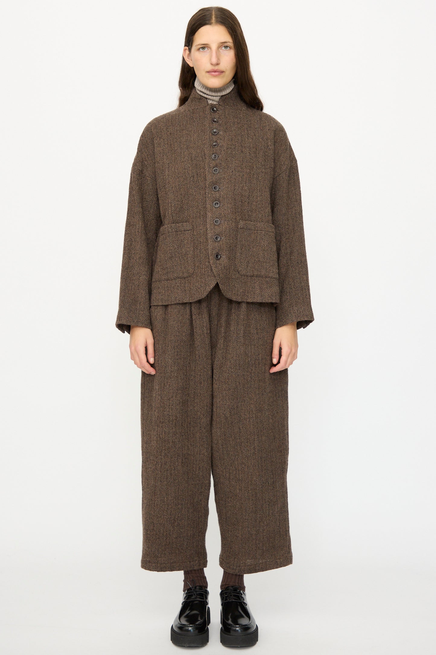 A woman wearing the Ichi Antiquités Wool Herringbone Jacket in Brown.