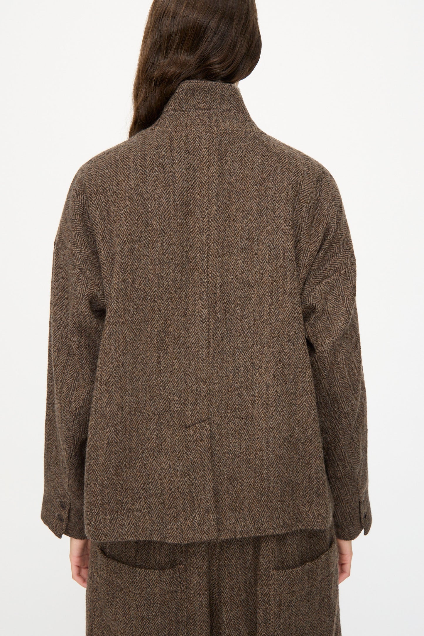 A person with long brown hair is seen from the back wearing the Ichi Antiquités Wool Herringbone Jacket in Brown with matching pants, posed against a plain background.