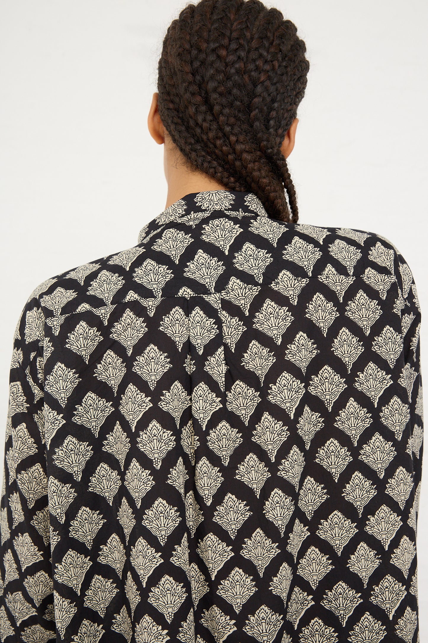 A person seen from behind wearing an Ichi Antiquités Woven Cotton Indian Block Print Dress in Black, with hair braided into thick cornrows.