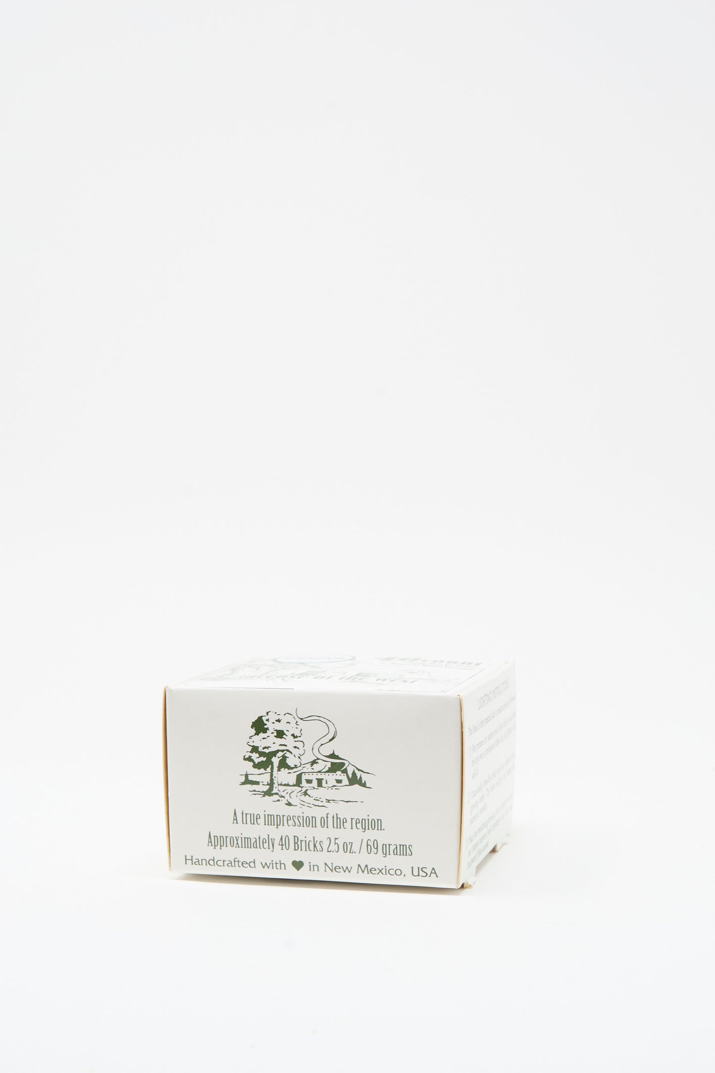 The Cedar Incense Box by Incense of the West is a small white box with green text and a lion illustration, containing about 40 handcrafted bricks made from New Mexican clay in New Mexico, USA.