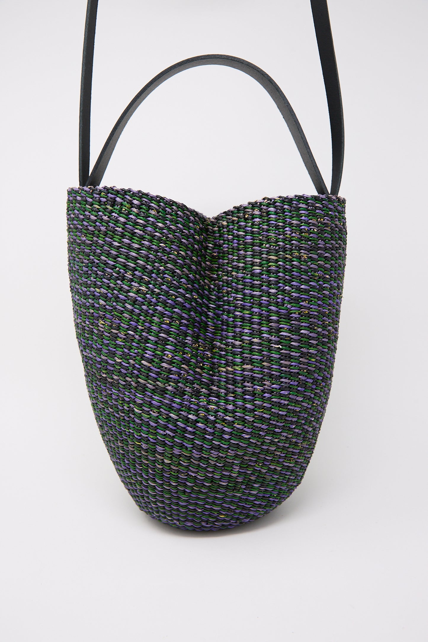 Handwoven N. 36 Haricot Bag in Green crafted from elephant grass with a multicolored pattern and black straps against a white background by Inès Bressand.