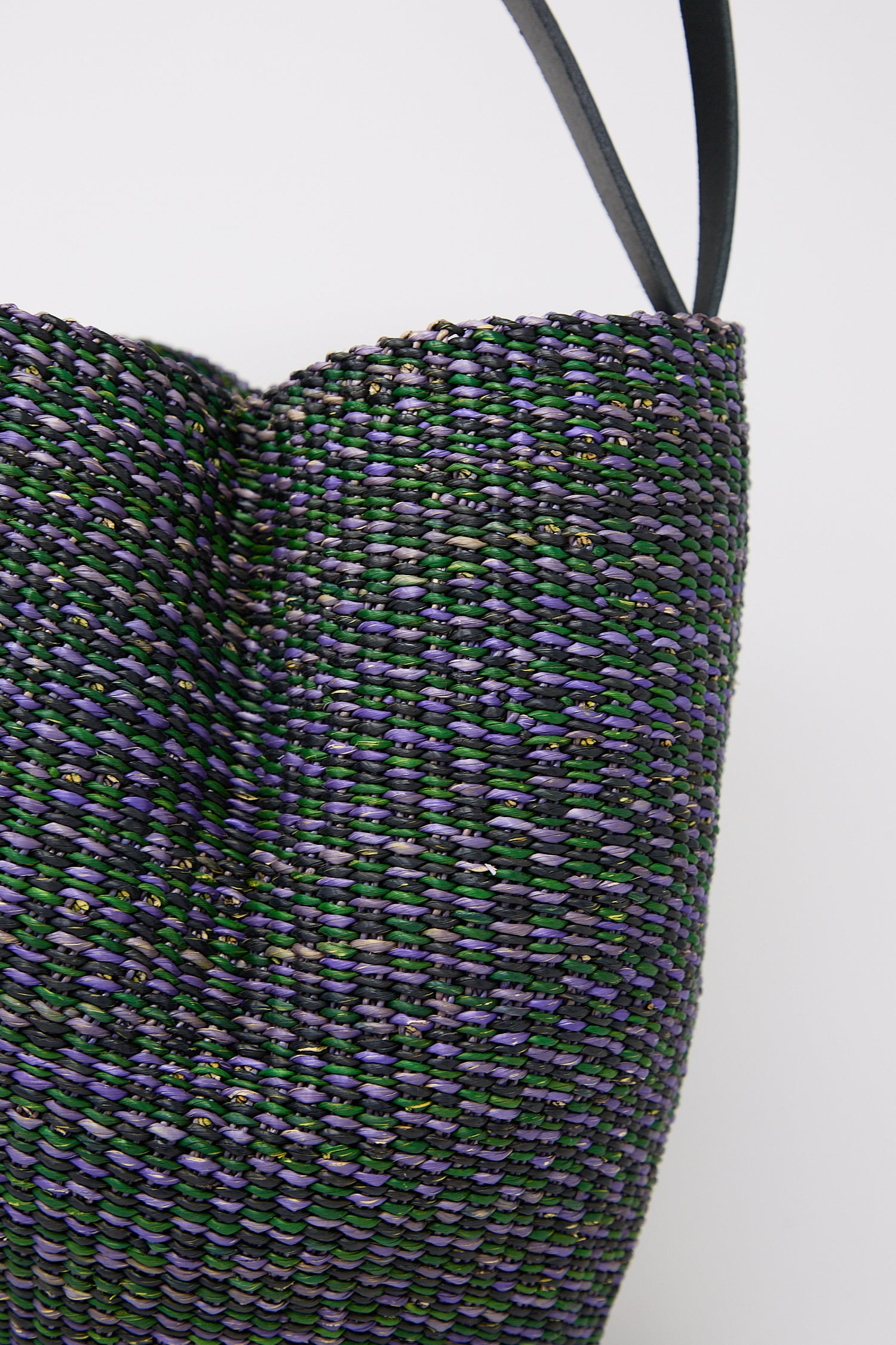 Close-up of a N. 36 Haricot Bag in Green with purple and green detailing against a white background by Inès Bressand.