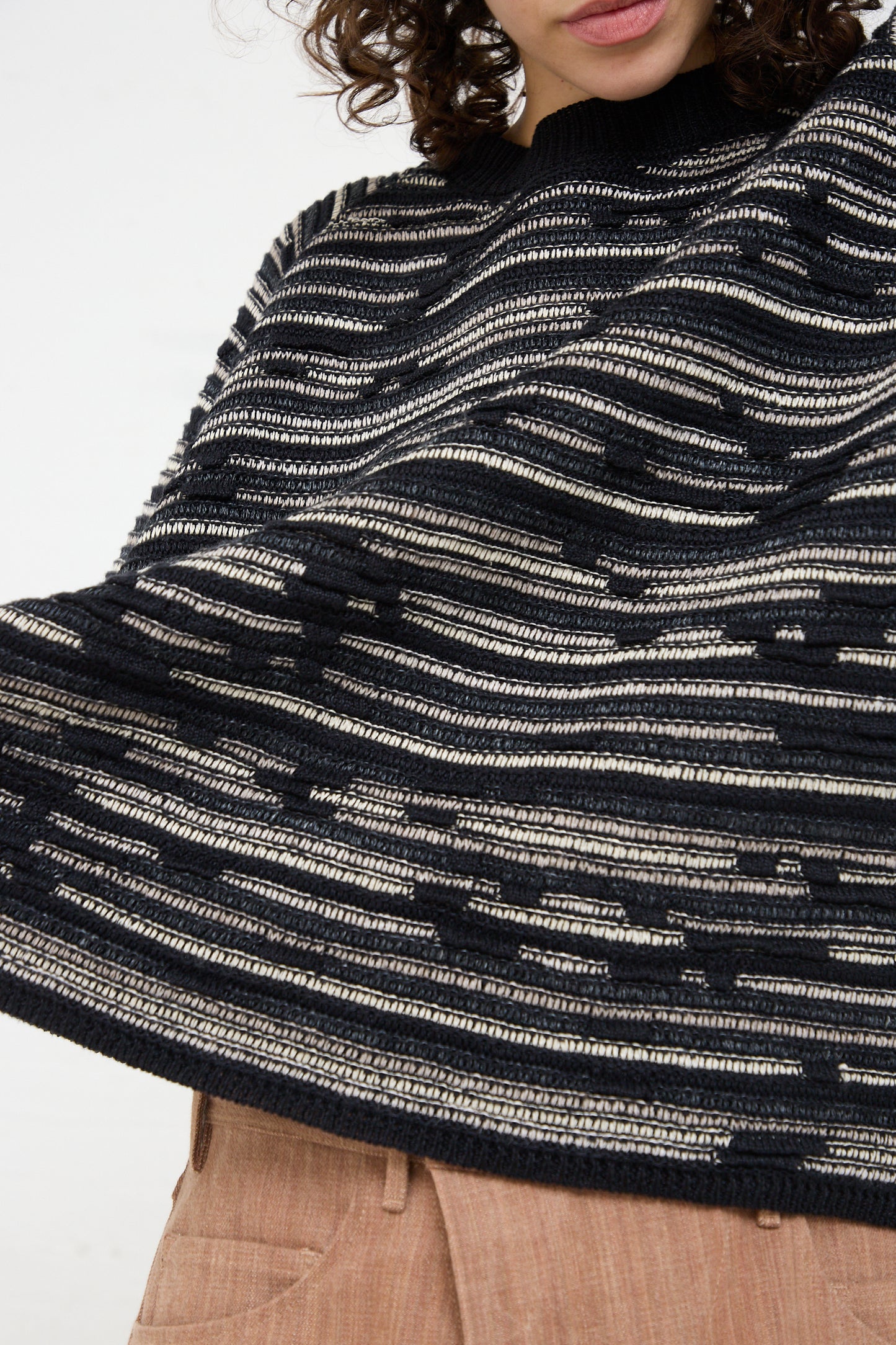 A woman in a Linen Cotton Knit Crewneck in Black made by Jan-Jan Van Essche.