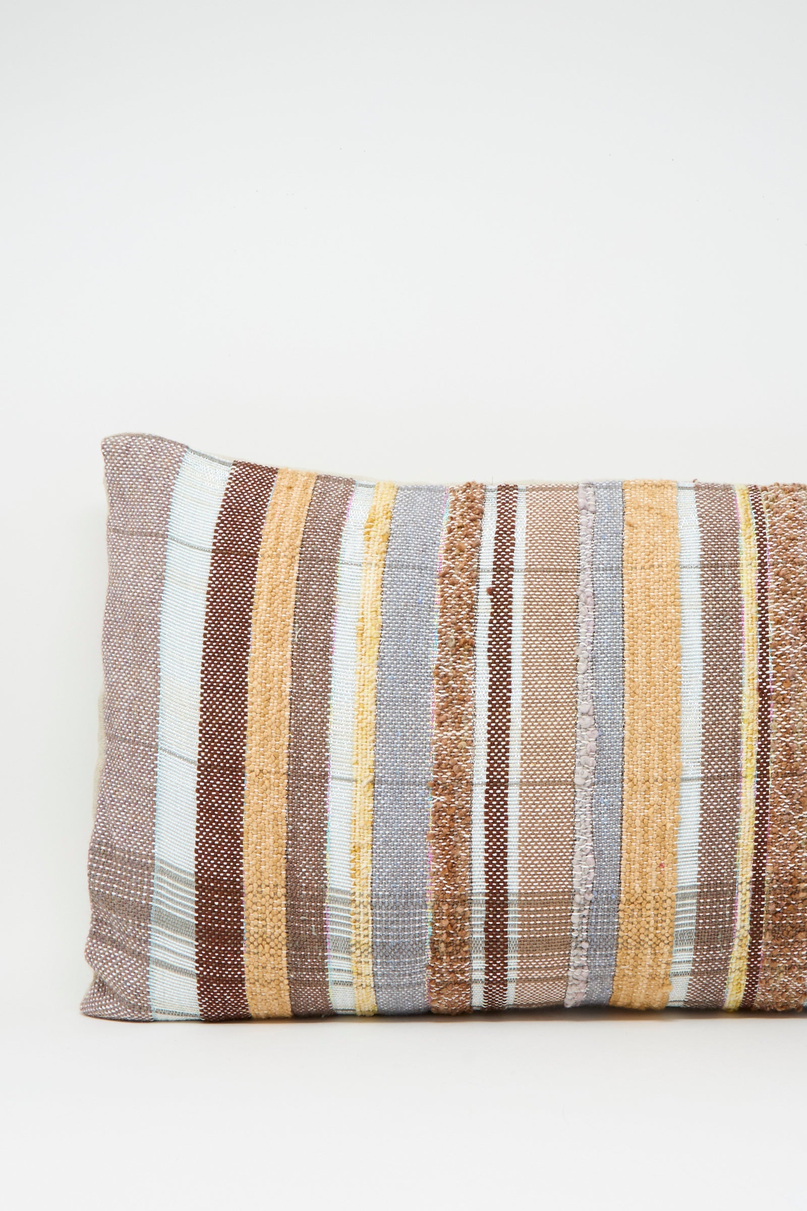 The Jess Feury Woven Pillow in Blue, Rust and Yellow Stripe is a rectangular, handwoven pillow featuring sustainable fibers and horizontal stripes, shown on a plain white background.