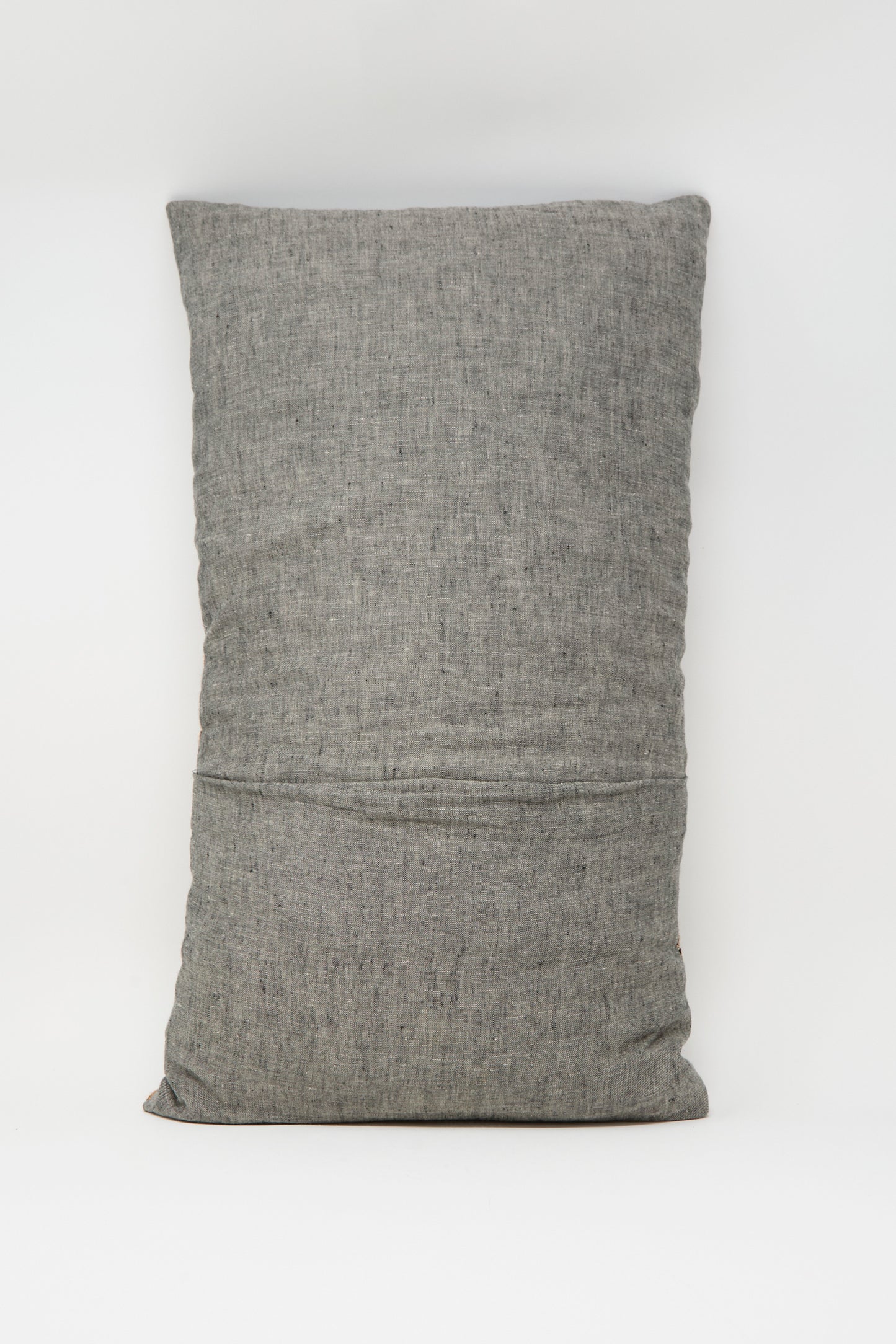 A rectangular Woven Pillow in Rust and Terracotta Stripe by Jess Feury, featuring handwoven construction with subtle texture, crafted from sustainable fibers and shown upright against a plain white background.