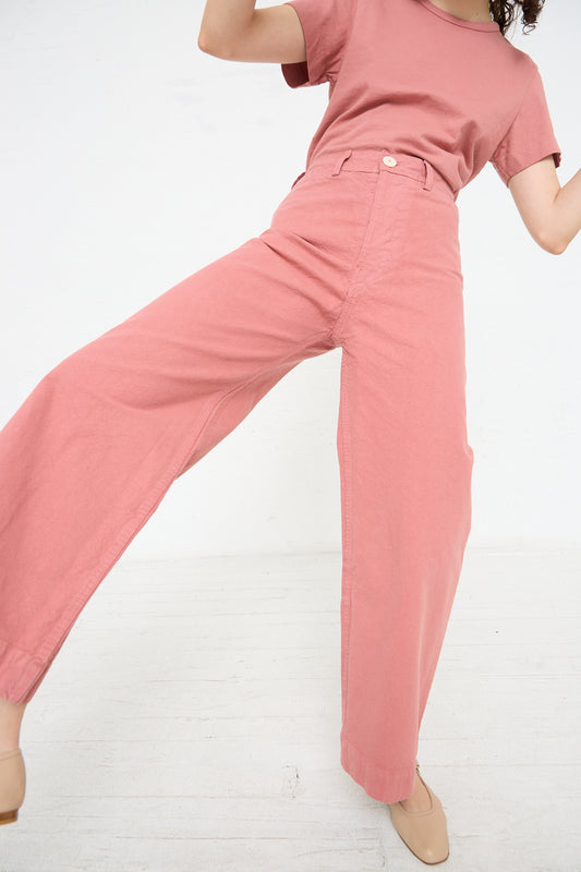 A woman wearing Jesse Kamm's Sailor Pant in Dogwood and a t-shirt.