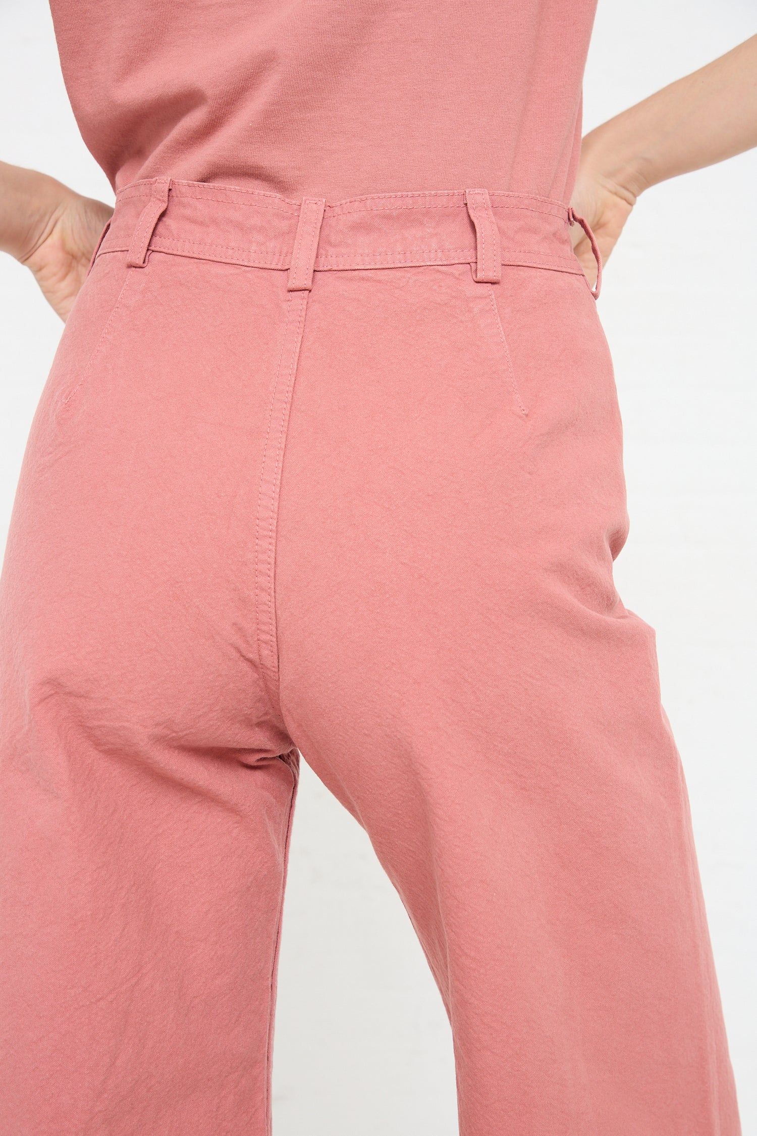 The woman is wearing pink Jesse Kamm Sailor Pants in Dogwood.