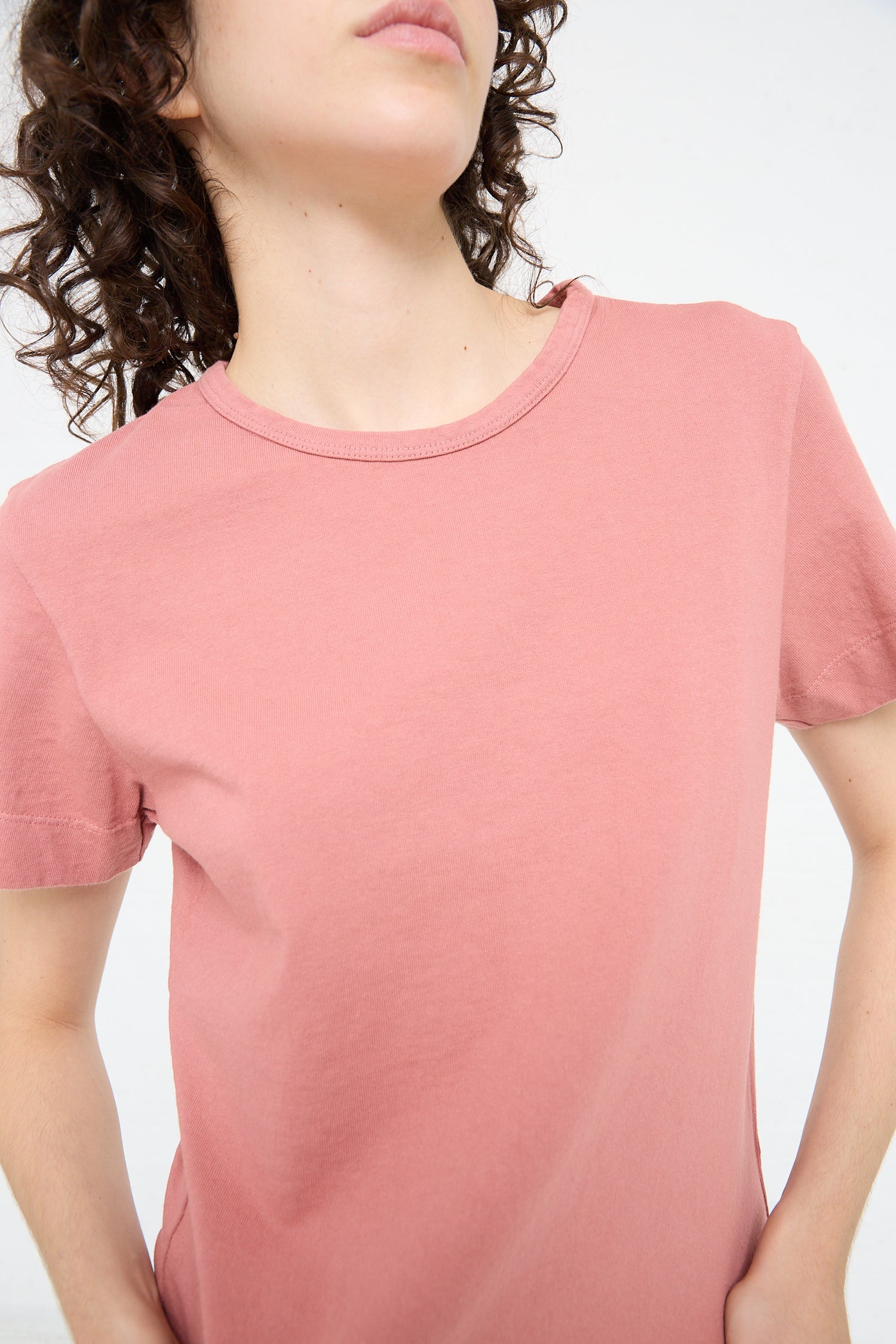 A woman in a pink Jesse Kamm Sailor Tee in Dogwood.