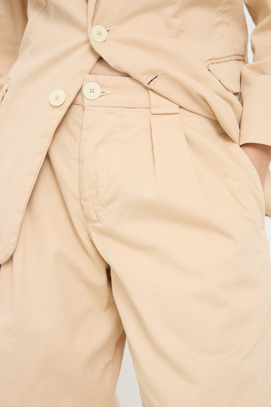 A man in a tan suit and beige pants, made from organic cotton twill: The Trouser in Buff by Jesse Kamm.