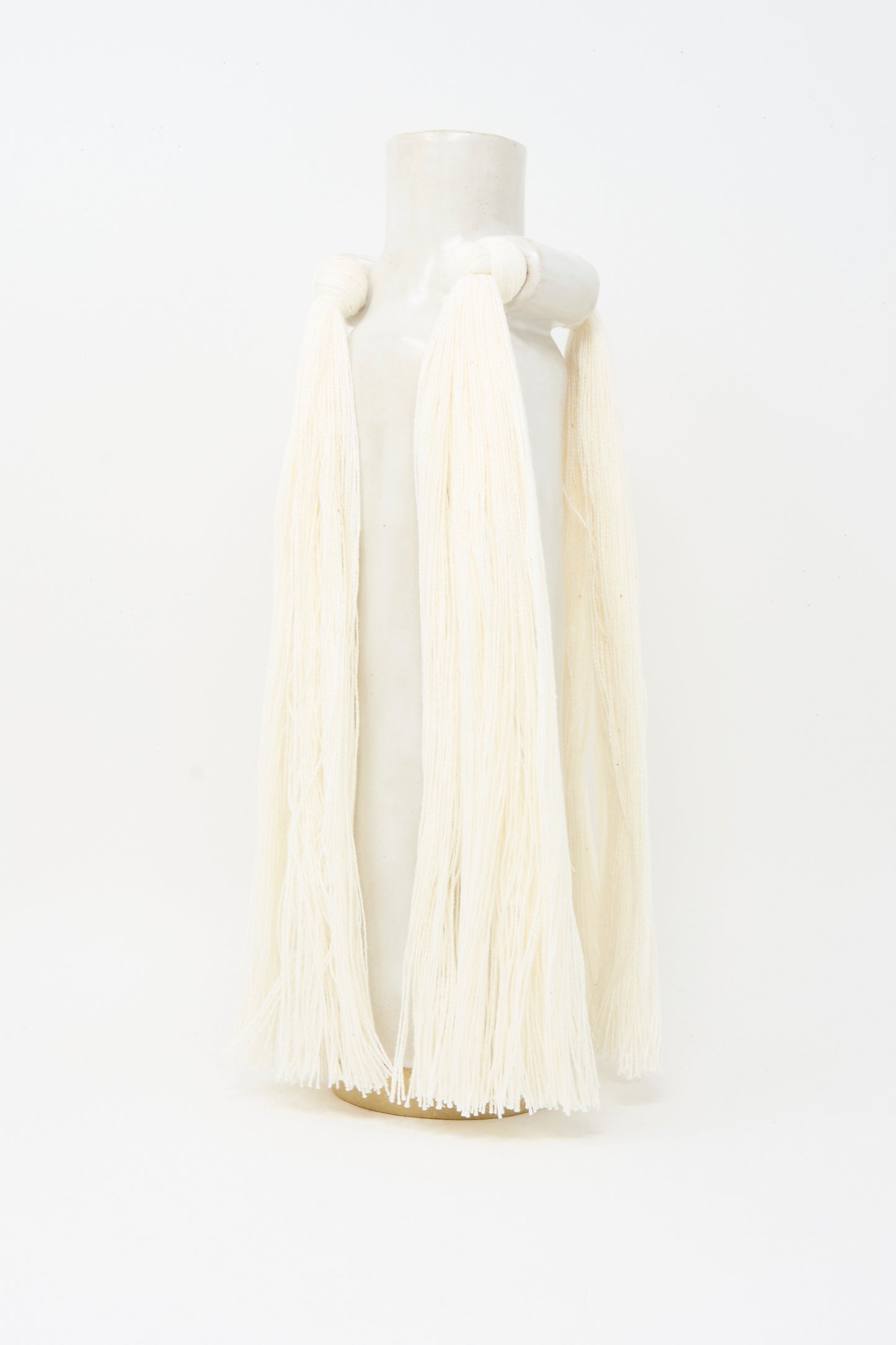 Vase #703 in White by Karen Tinney is a handmade white stoneware vase with two looped handles draped in off-white yarn, crafted in Vermont and shown against a plain white background.
