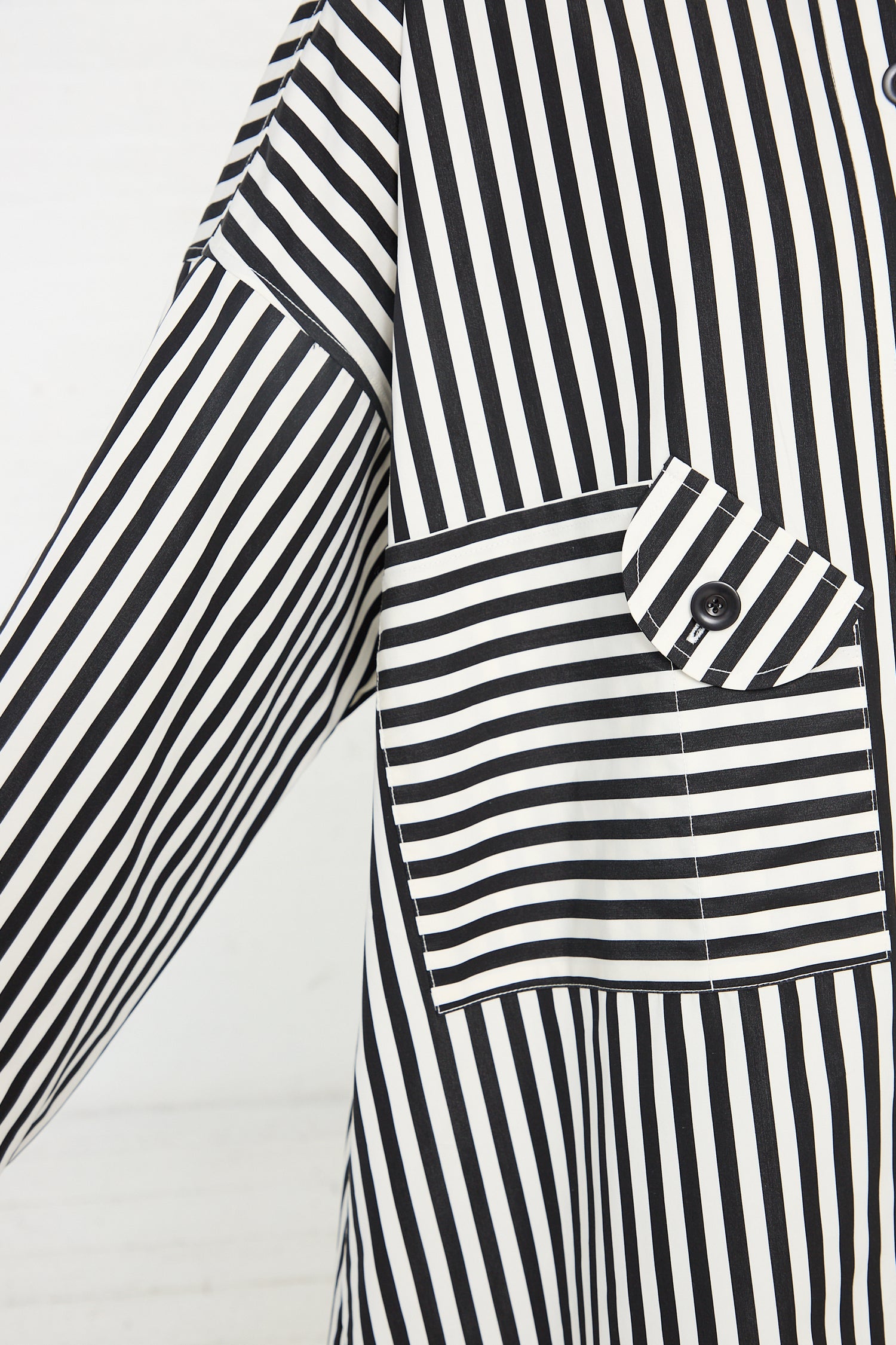 Close-up of a KasMaria Cotton Poplin Oversized Smock Dress in Stripe with a focus on the playful pocket detail.