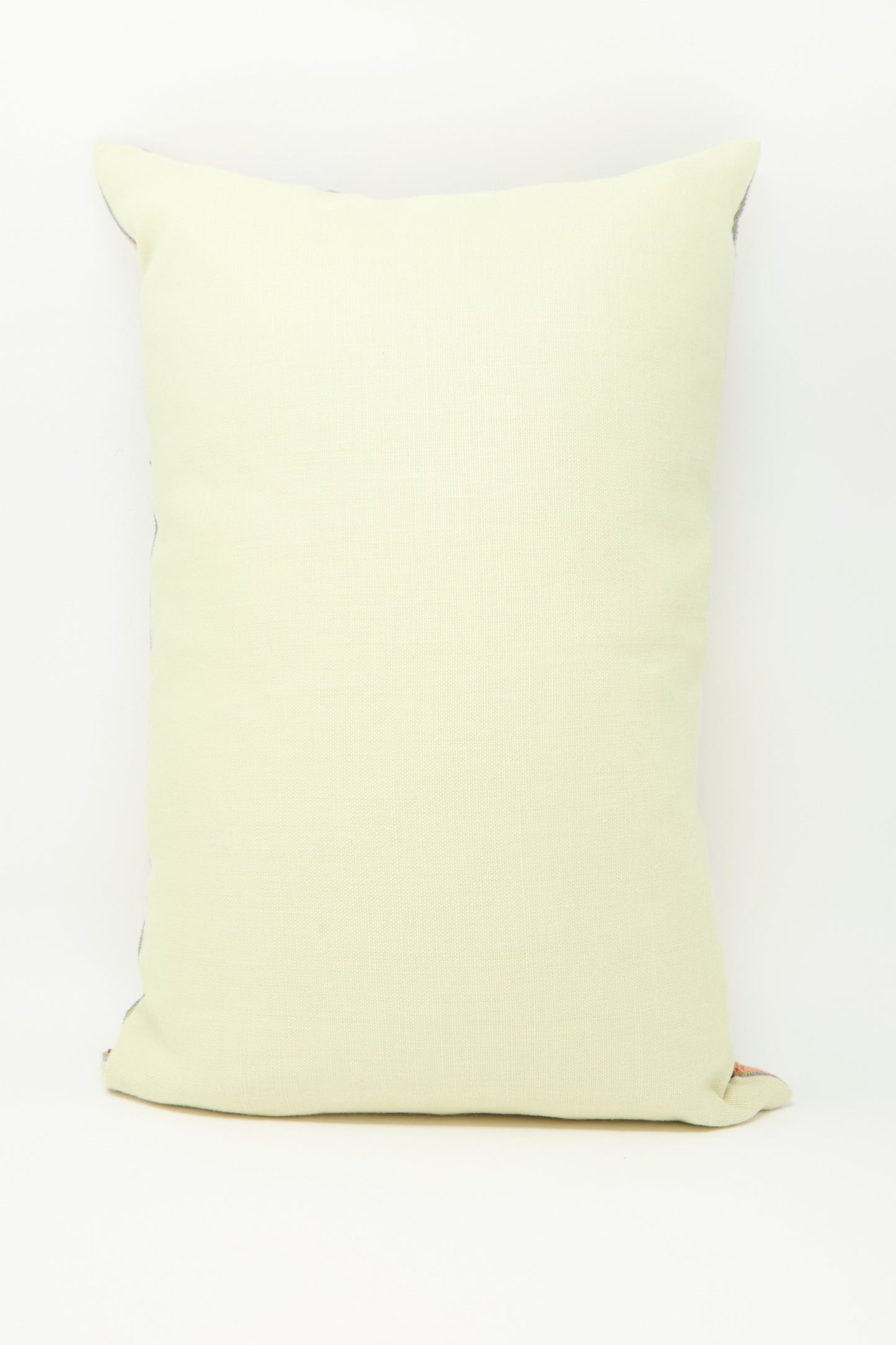 The Imm Bushra Hand Embroidered Pillow in Olive by Kissweh is propped upright against a plain white background.