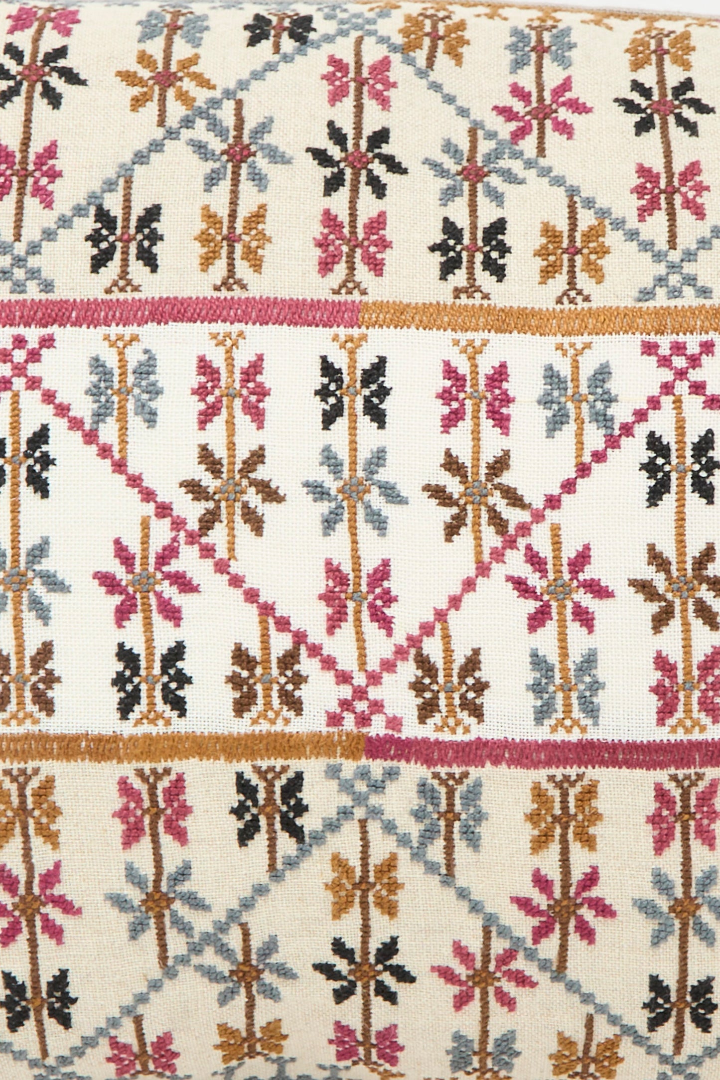 The Kissweh Imm Omar Hand Embroidered Pillow in Beige and Chocolate features geometric patterns in brown, pink, black, and blue on a cream background—crafted from luxurious Libeco Belgian linen for a refined accent.