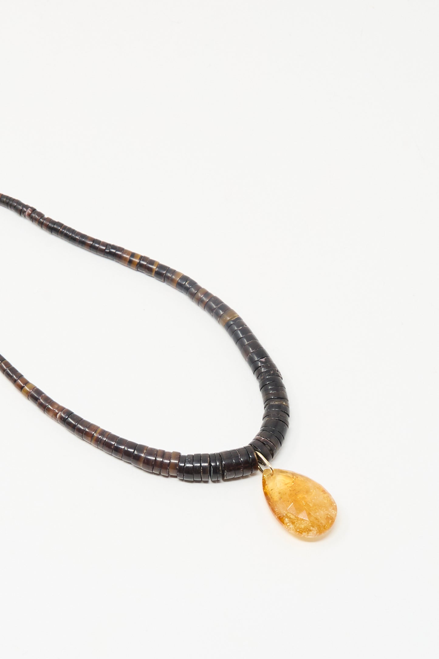 The Drop Collar in Sunset by Laoli: a handmade citrine necklace with dark round beads and a single yellow teardrop pendant, displayed on a white background.
