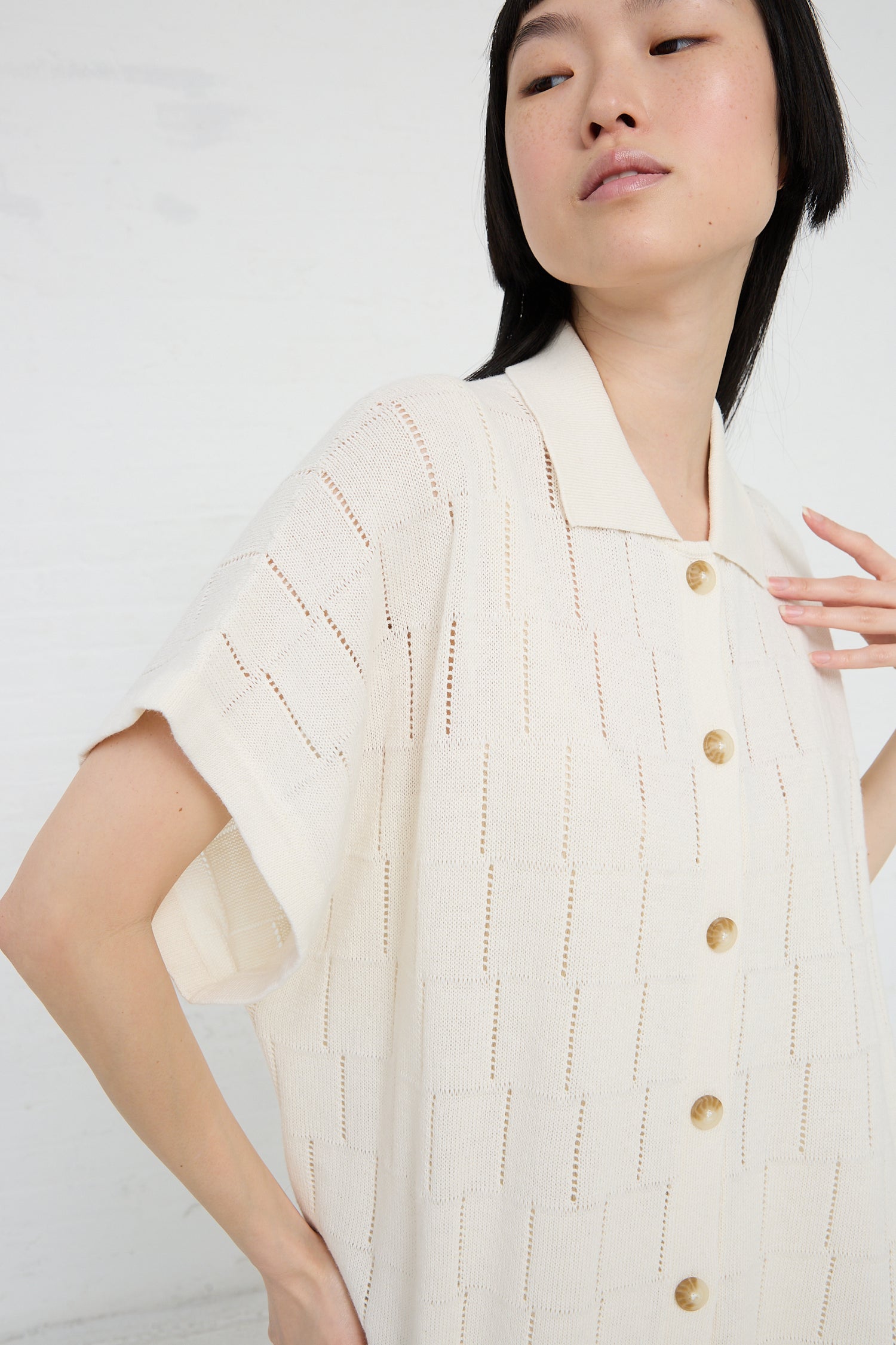Woman posing in a Lattice Shirt Dress in Bone by Lauren Manoogian, made of cream textured linen blend fabric with button details.