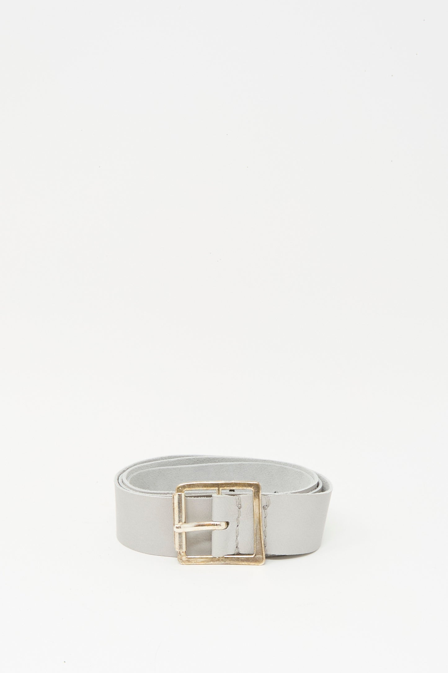The Lauren Manoogian Plata Belt in Gris features light gray leather with a handmade silver buckle, shown on a plain white background.