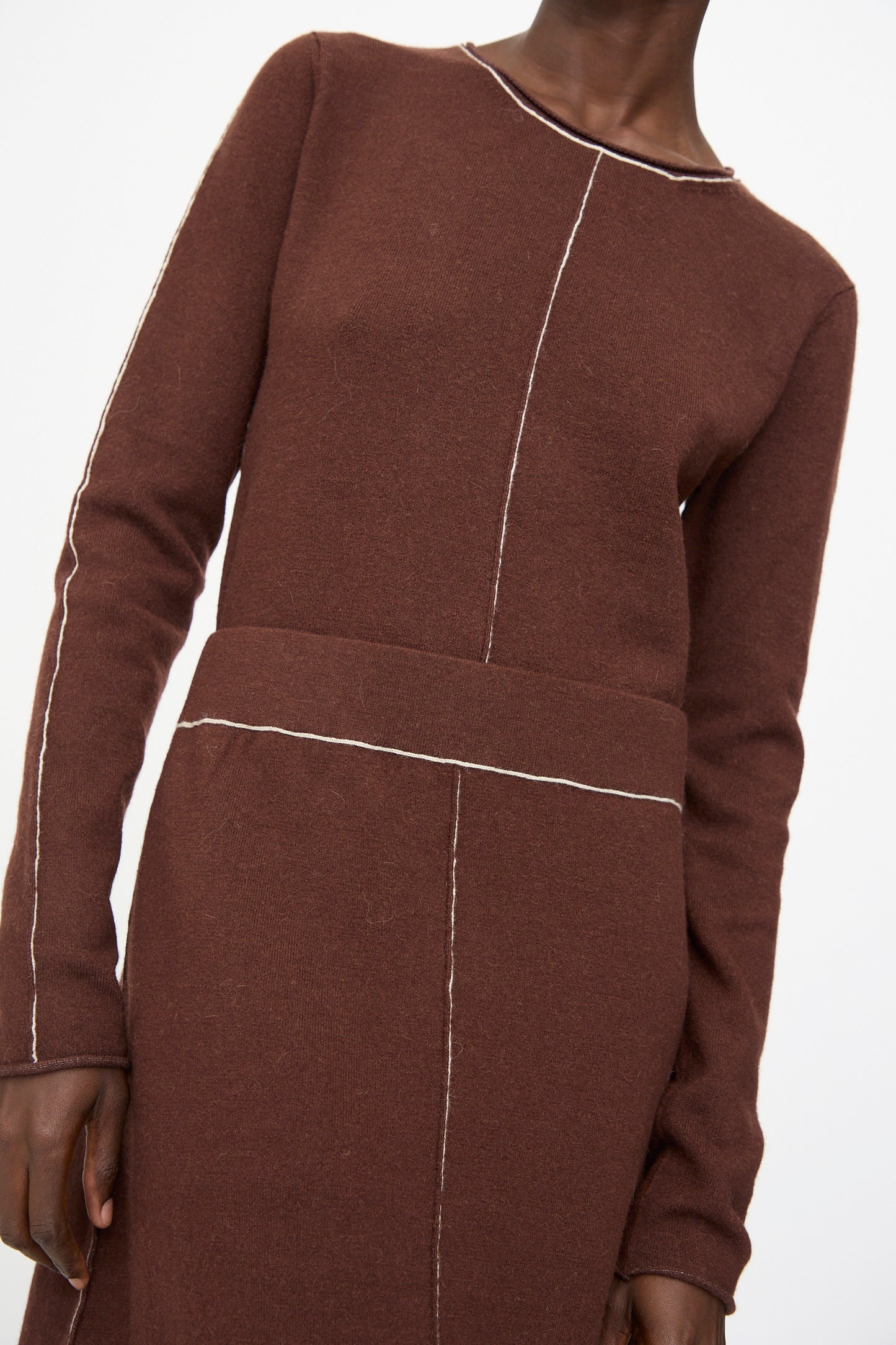 Model wears the Lauren Manoogian Stitch Skirt in Merlot, featuring visible white seam stitching, shown from shoulders to upper thigh.