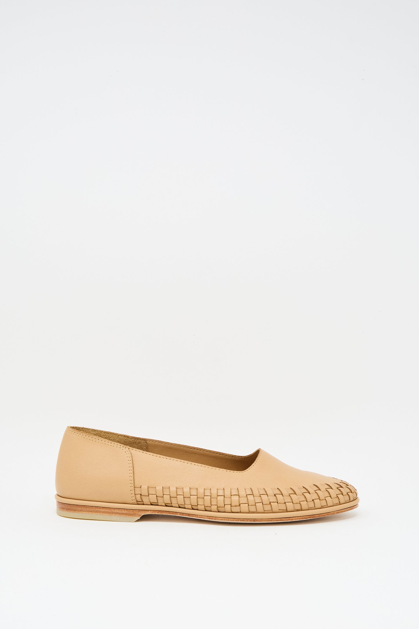 The Lauren Manoogian Weave Shoe in Natural is a beige leather slip-on with woven front detailing and a subtle woven rim, shown against a plain white background.