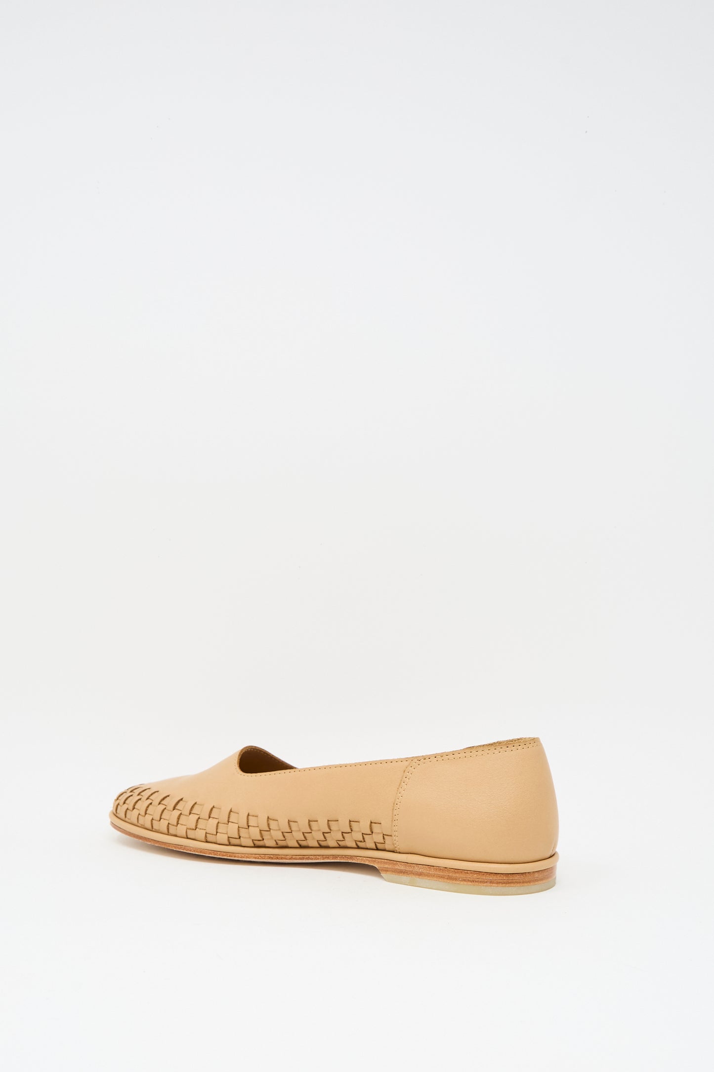 The Lauren Manoogian Weave Shoe in Natural is a tan leather slip-on with a woven rim on the front and smooth back, shown against a plain white background.