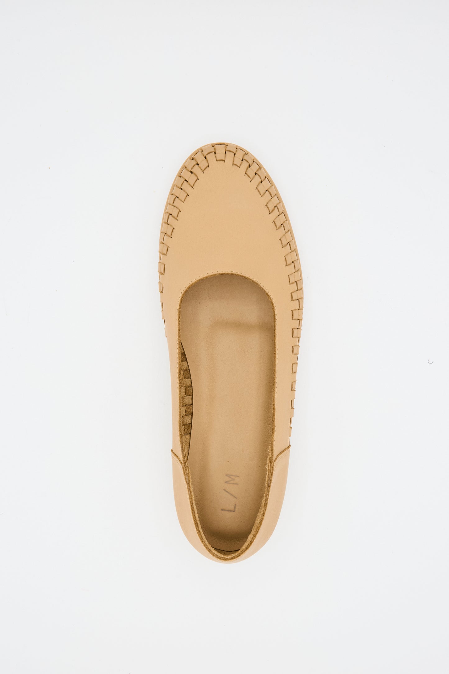The Lauren Manoogian Weave Shoe in Natural is a beige leather slip-on with woven rim detail, made from natural leather and shown from above on a plain white background.