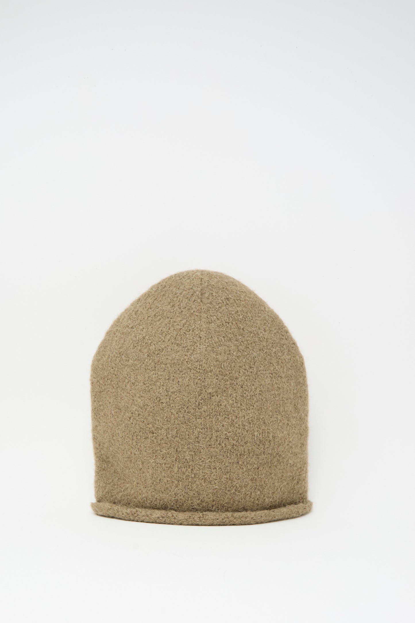 The Lauren Manoogian Crown Beanie in Tobacco is a light brown, hand-loomed alpaca knit with a rounded top and simple rolled edge, shown against a white background.