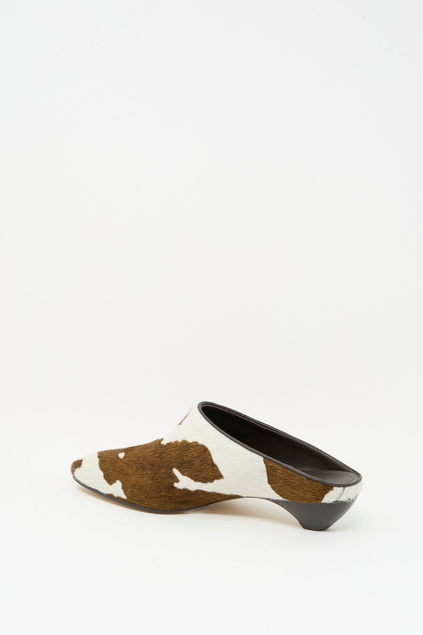 The Allegra Mule in Cow by Le Monde Beryl features brown and white calf hair leather with a low black heel, displayed against a plain white background.