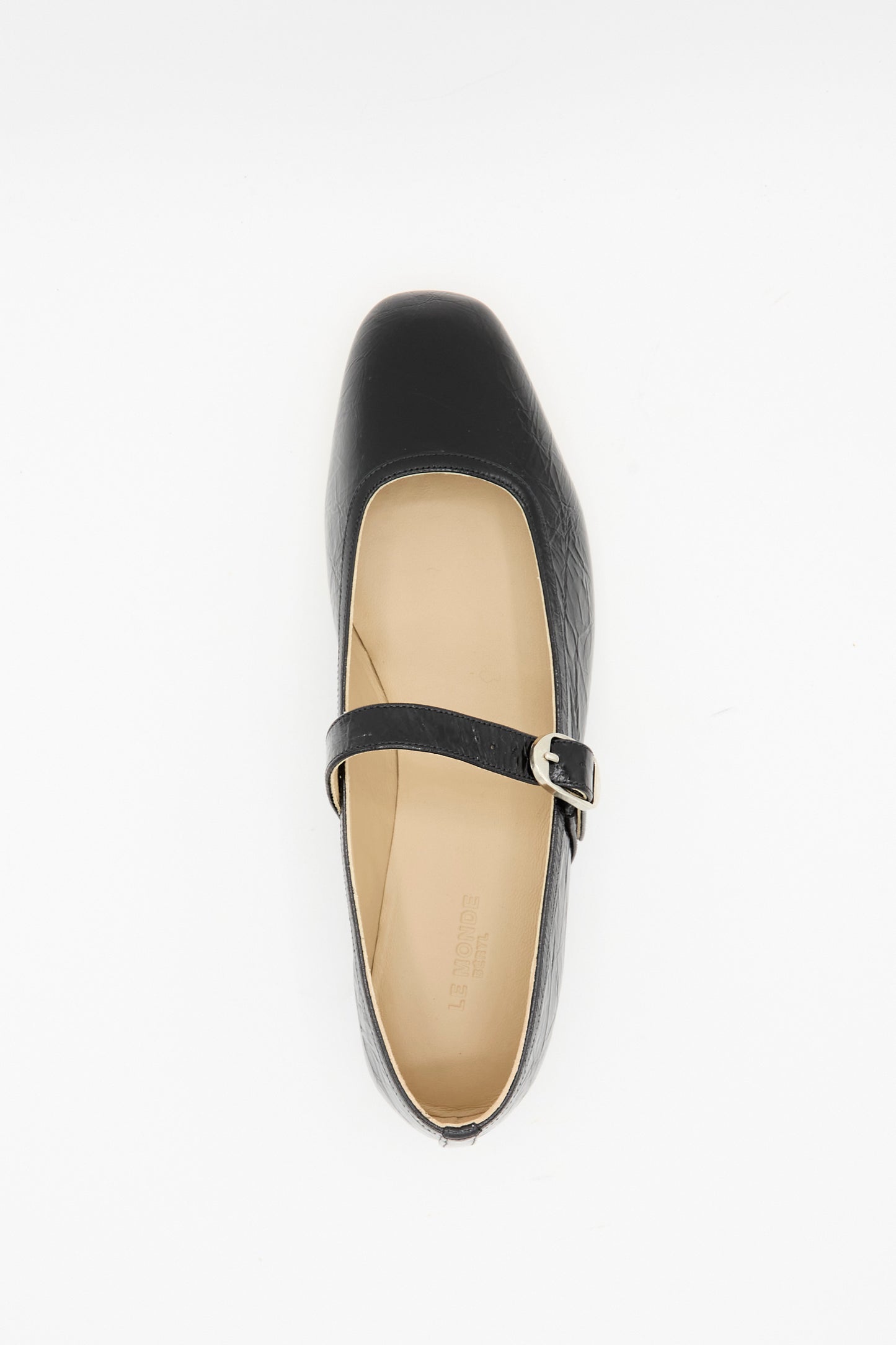 The Ballet Mary Jane in Black by Le Monde Beryl features a single lambskin leather shoe with a square toe and buckle strap, photographed from above on a white background.