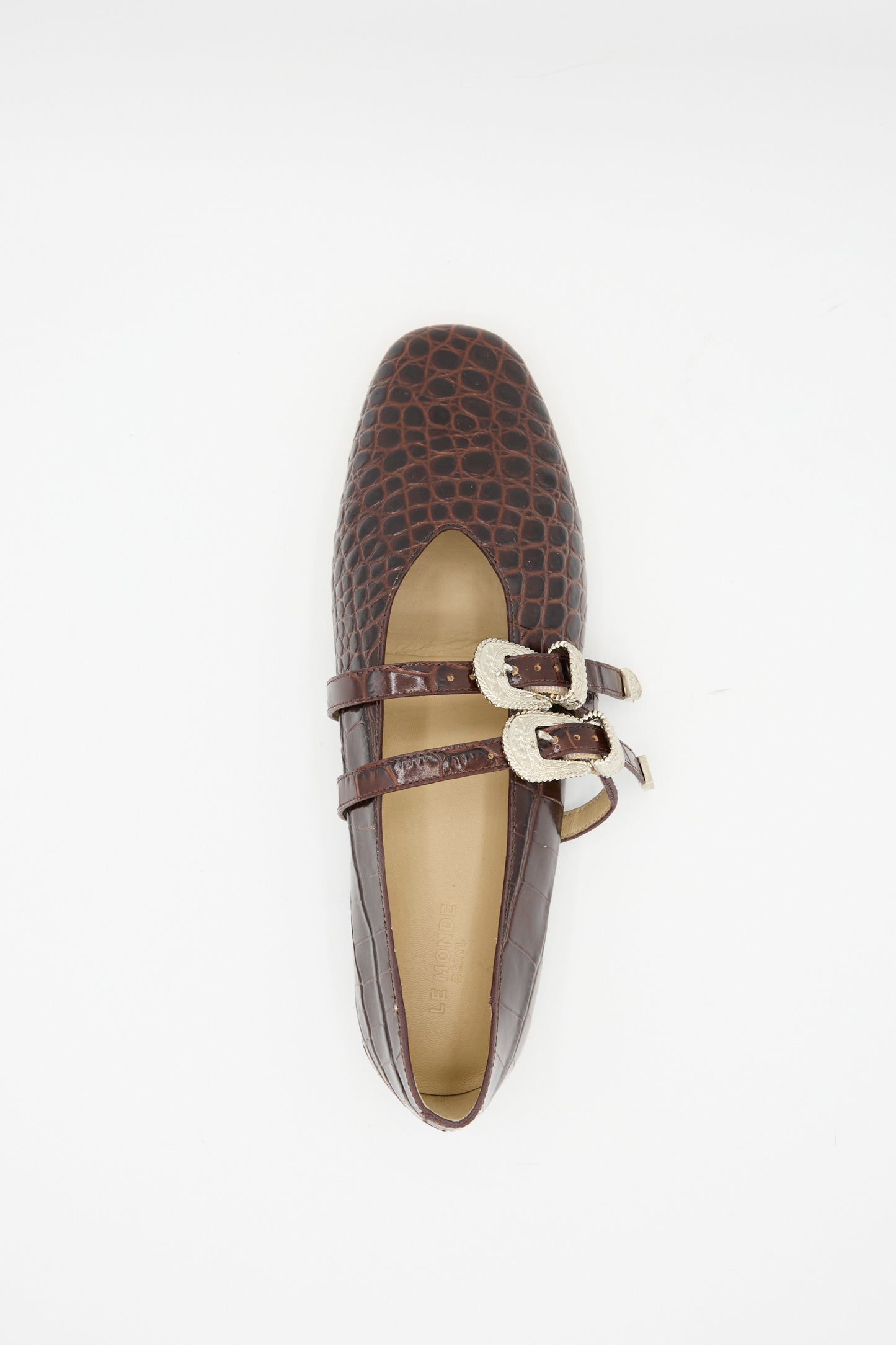 The Claudia Slipper in Coco Brown by Le Monde Beryl features premium calf leather with a crocodile pattern, two straps with silver buckles, and is shown from above against a white background.